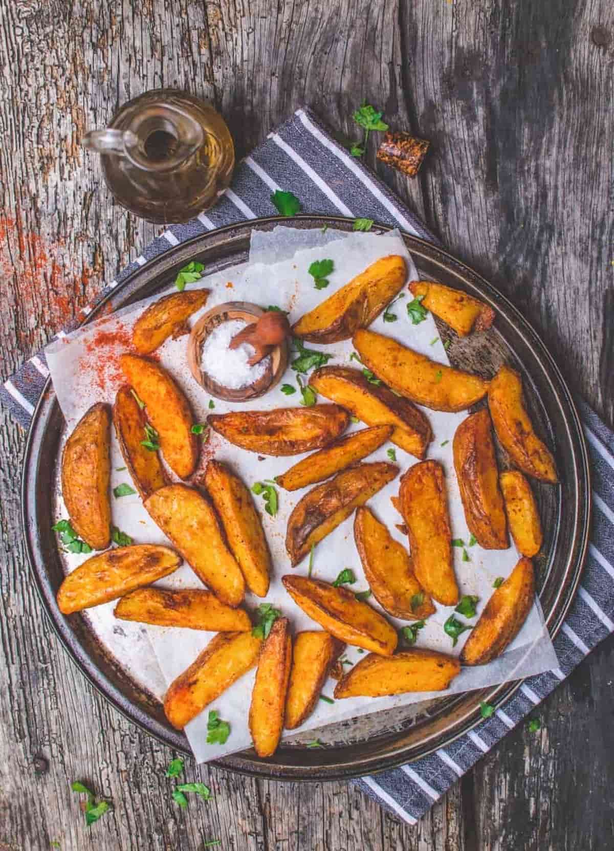 A plate of baked potato wedges.
