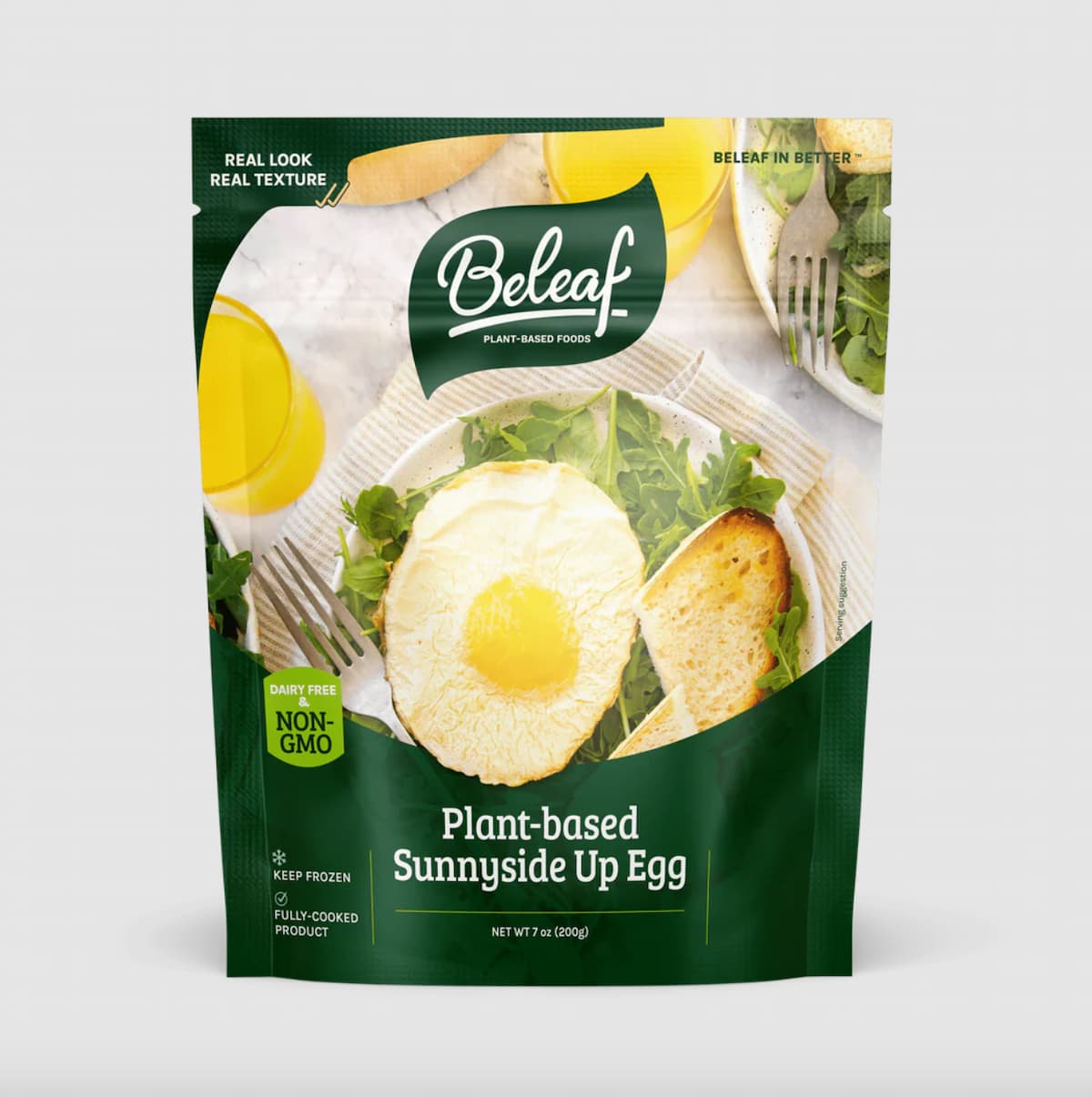 A green package of Beleaf plant-based, sunny-side up, vegan egg against a gray background.