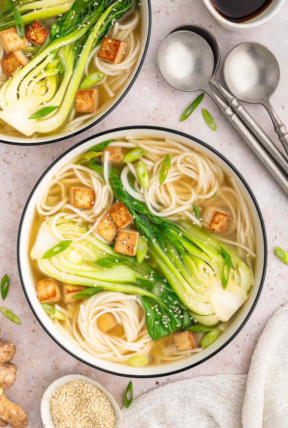 Bok choy miso soup with tofu and noodles in a light savory broth.