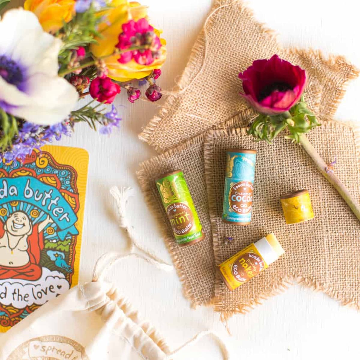 An assortment of Booda Organics brand vegan lip balm.