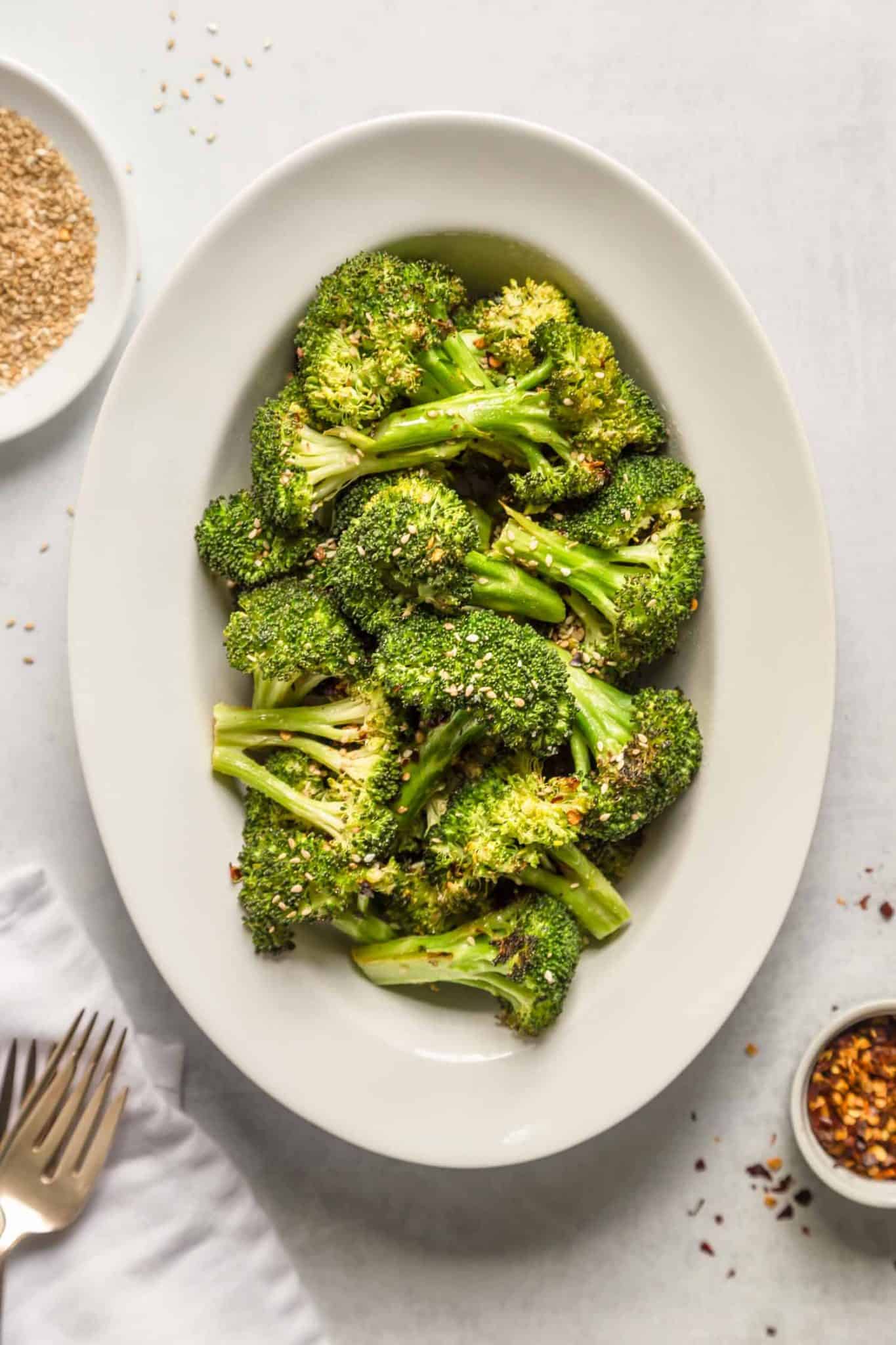 An oval plate with crispy broccoli.