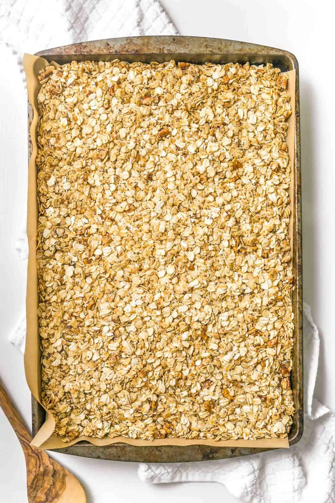 Homemade vegan granola pressed into a baking tray.