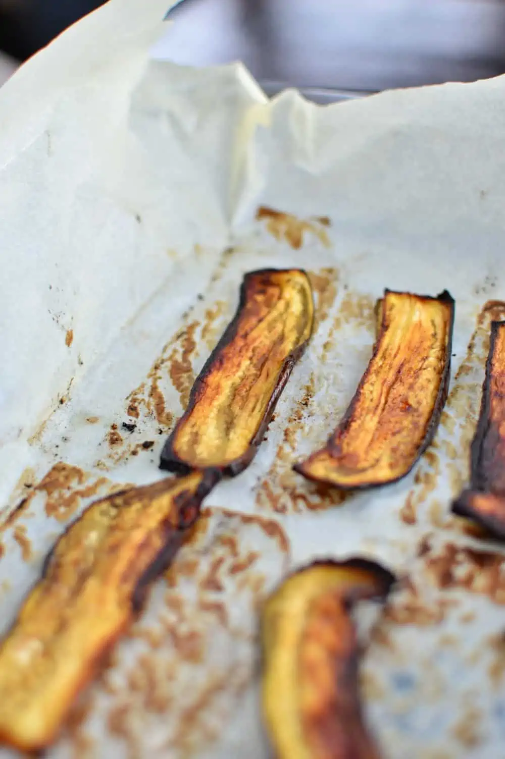 Baked eggplant bacon on a baking tray.