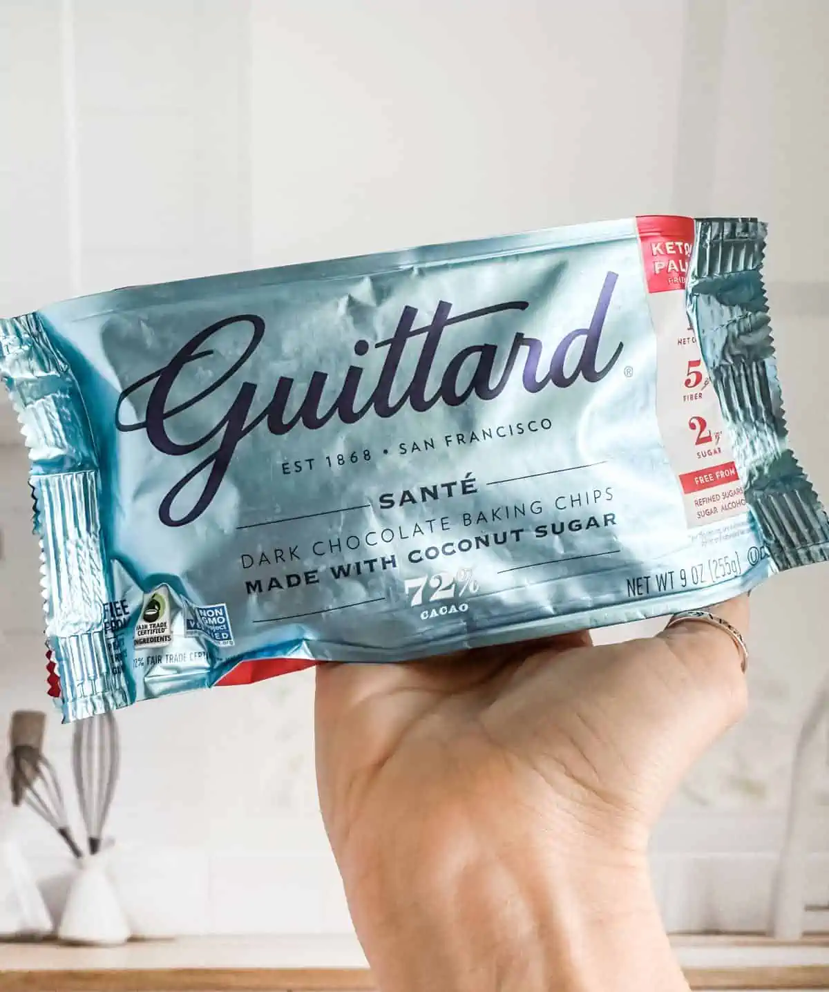 Light blue shiny bag of Guittard accidentally vegan chocolate chips.