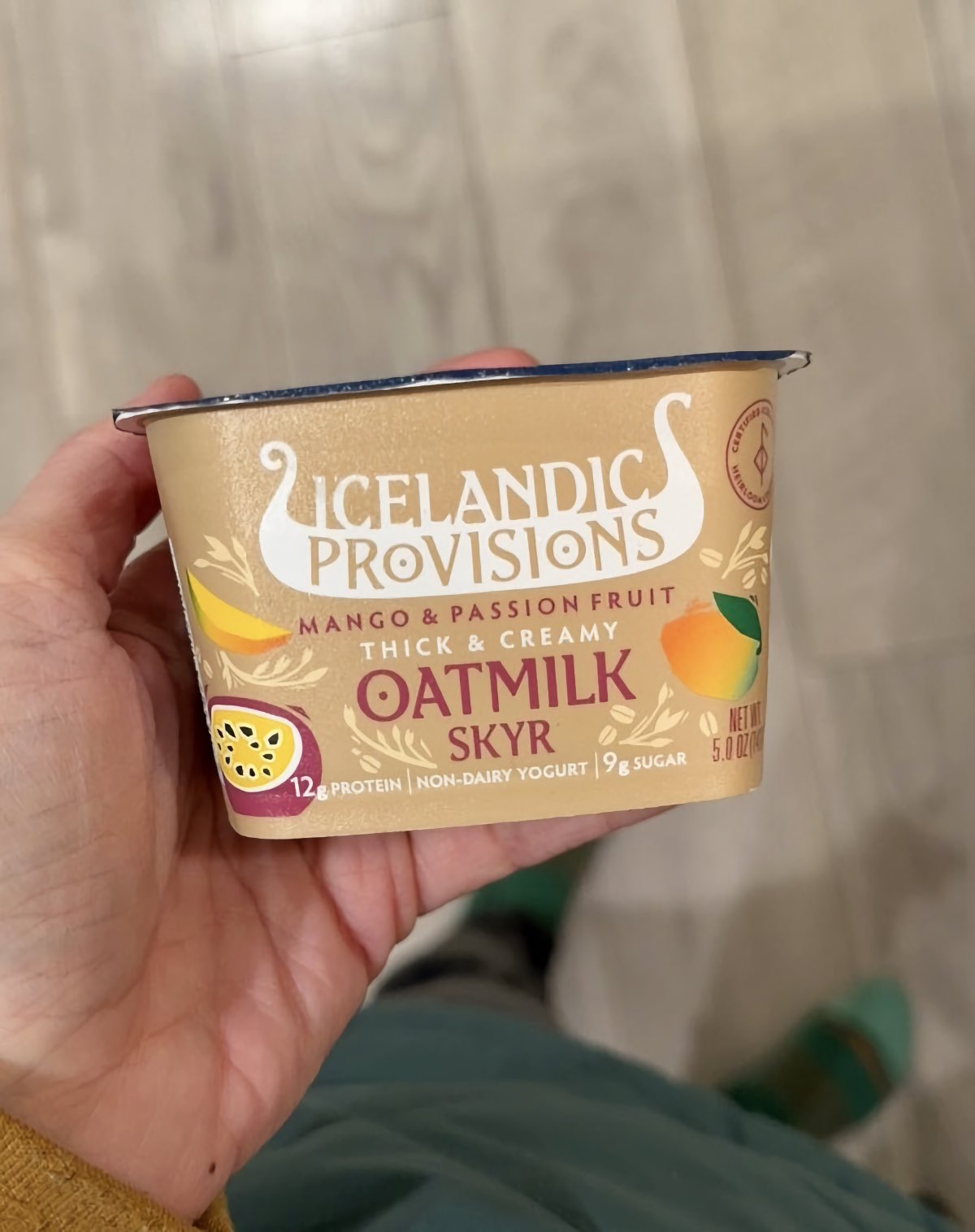 A container of passionfruit flavored oatmilk vegan yogurt from Icelandic Provisions.