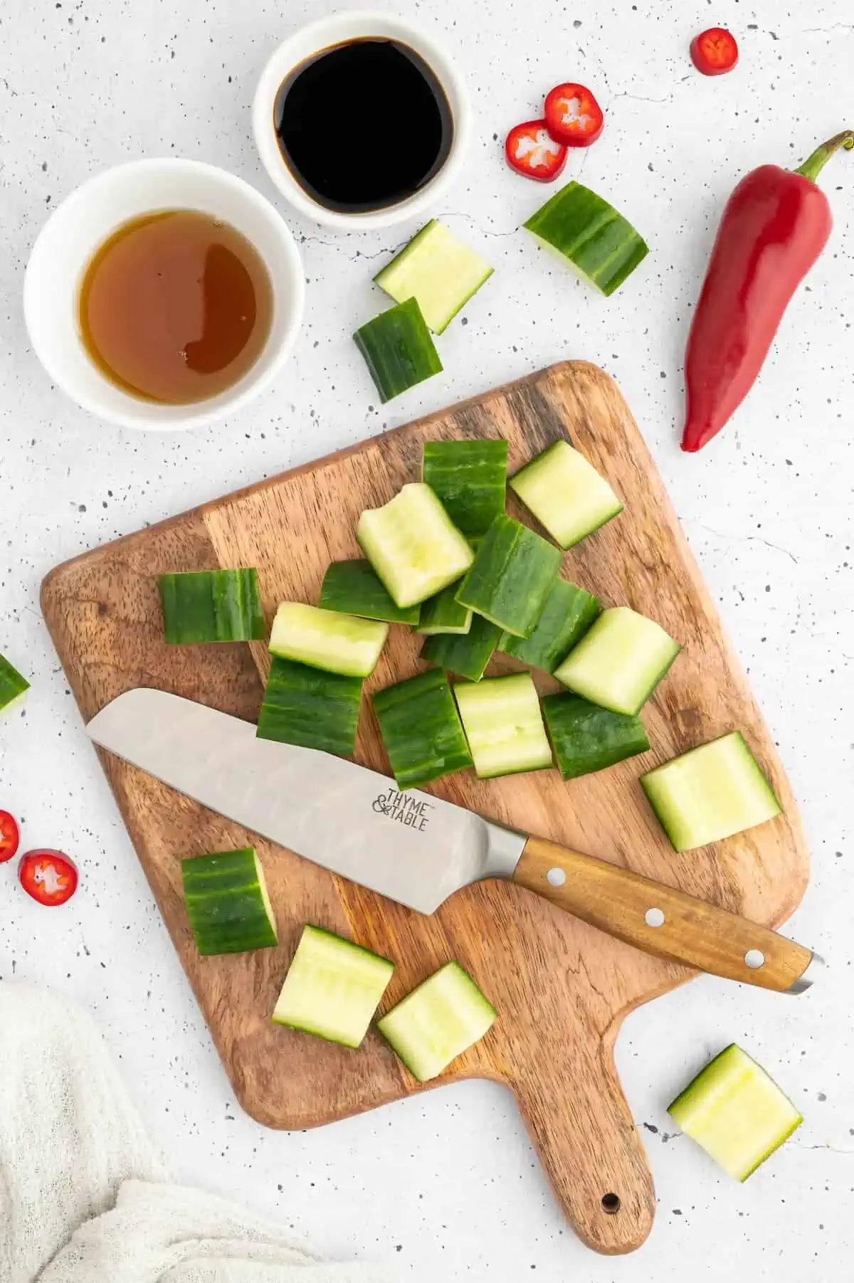 A cucumber chopped into pieces to prep Japanese pickled cucumber.