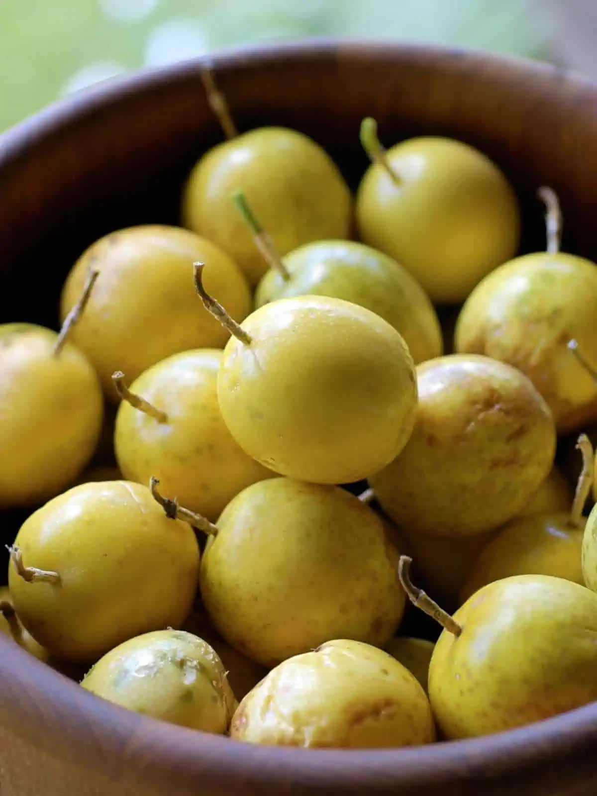 A bowl filled with yellow lilikoi.