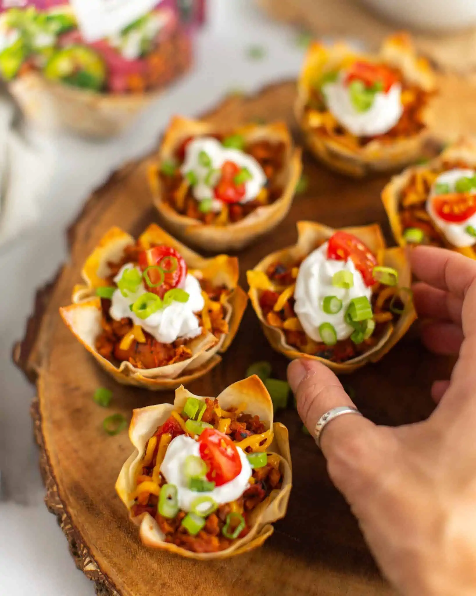Vegan wonton cups with crispy edges and garnishes.