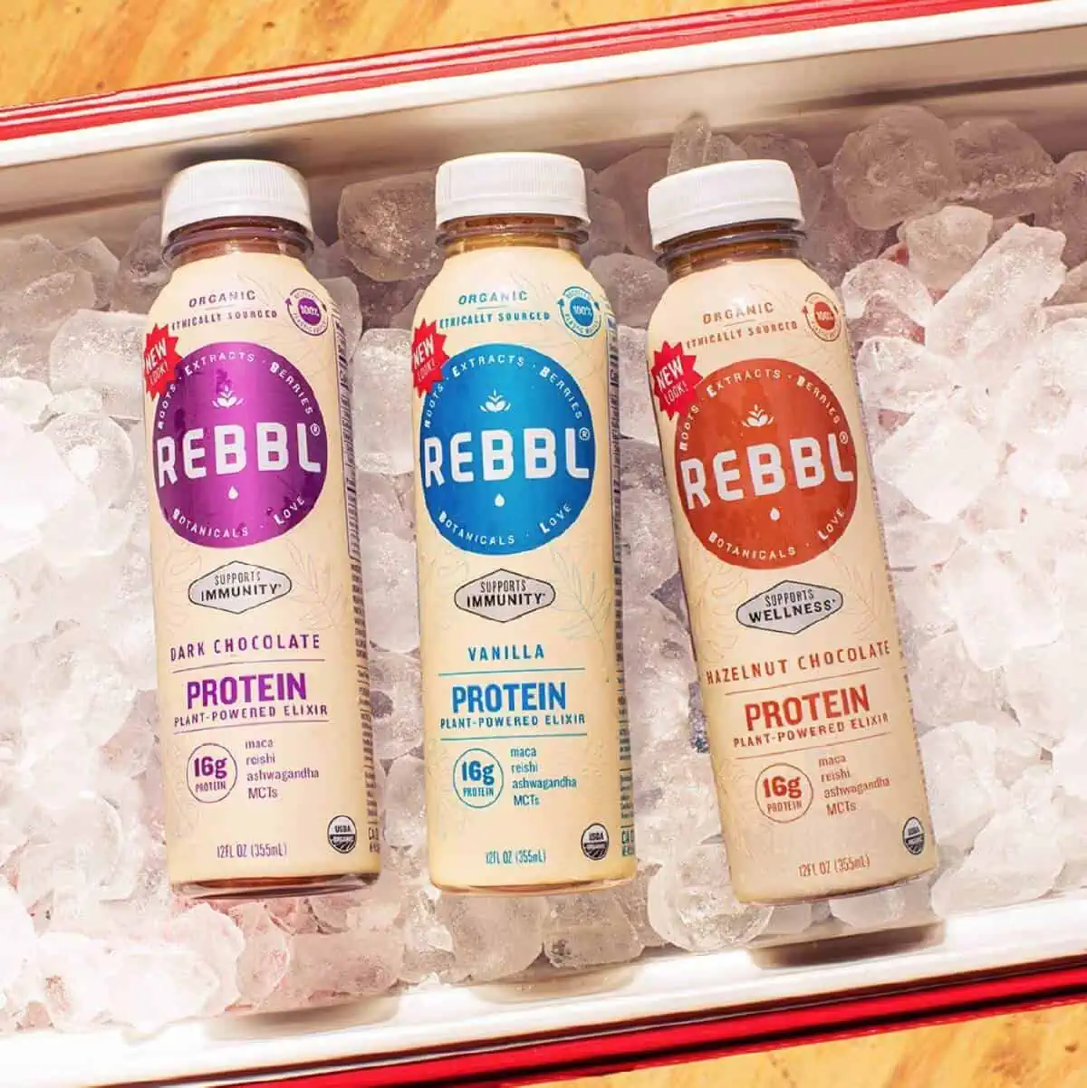 Three bottles of Rebbl plant-based shakes in a cooler of ice.