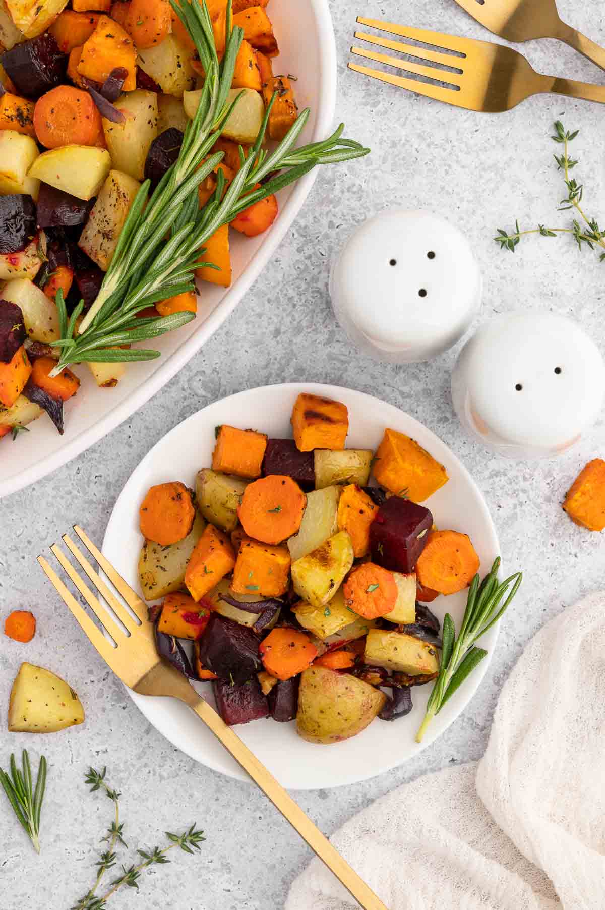 Roasted root vegetables in a bowl – colorful vegan Rosh Hashanah side dish with fall produce.