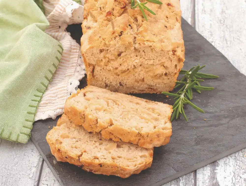Rustic vegan rosemary beer bread loaf with crisp crust and soft crumb.