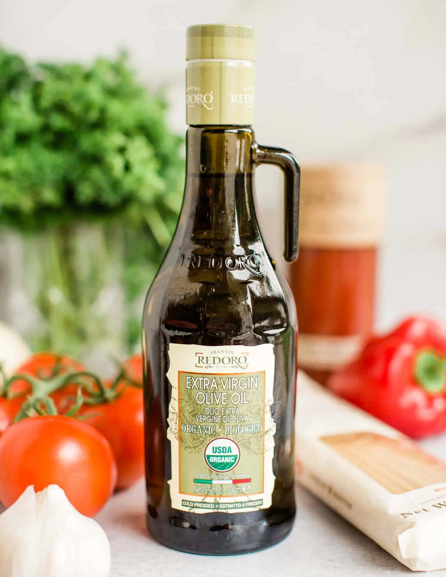 A bottle of extra virgin olive oil, one of the most used vegan pantry essentials.