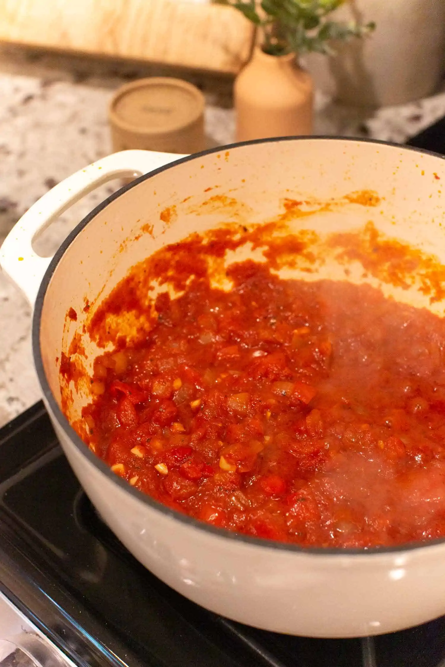 Cooked arrabiata sauce on the stove in a dutch oven pot.