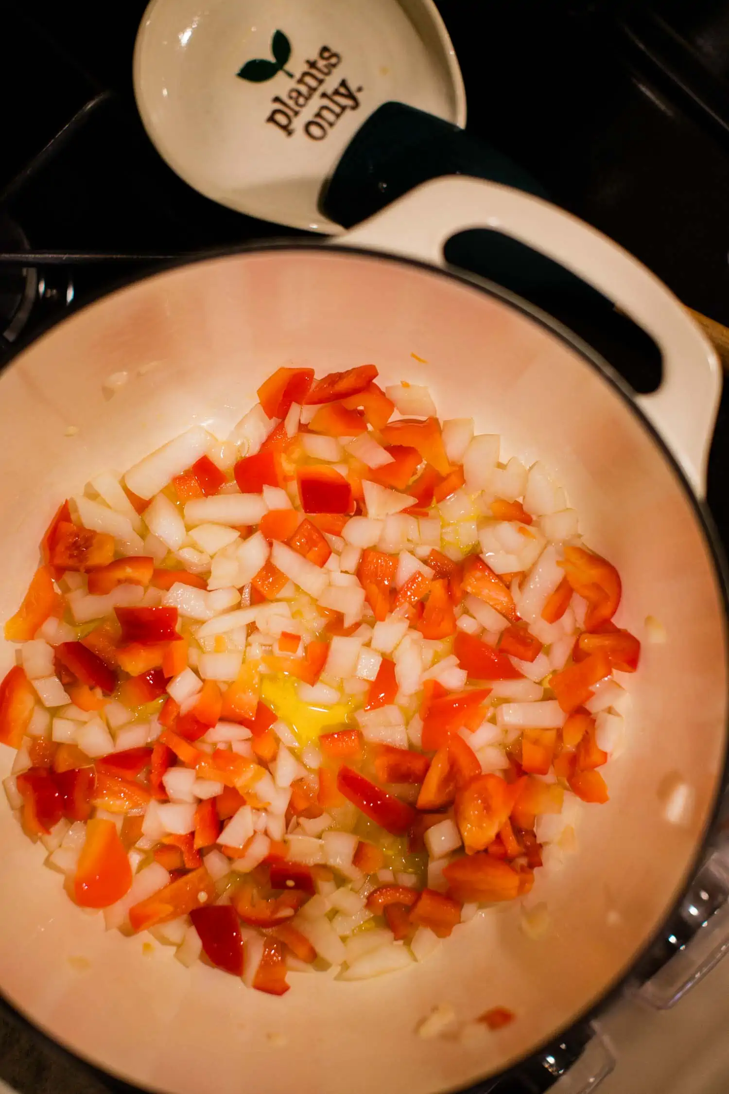 Sauteeing onion, garlic, and bell pepper in large Dutch oven pot.