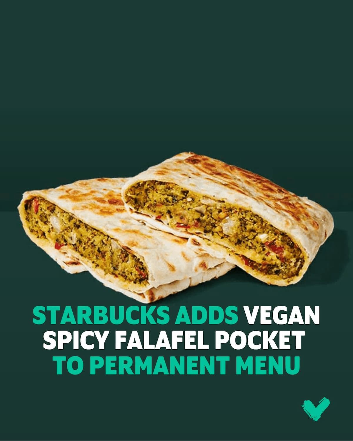 A rectangular vegan Starbucks Spicy Falafel sandwich cut in half on a dark green background.