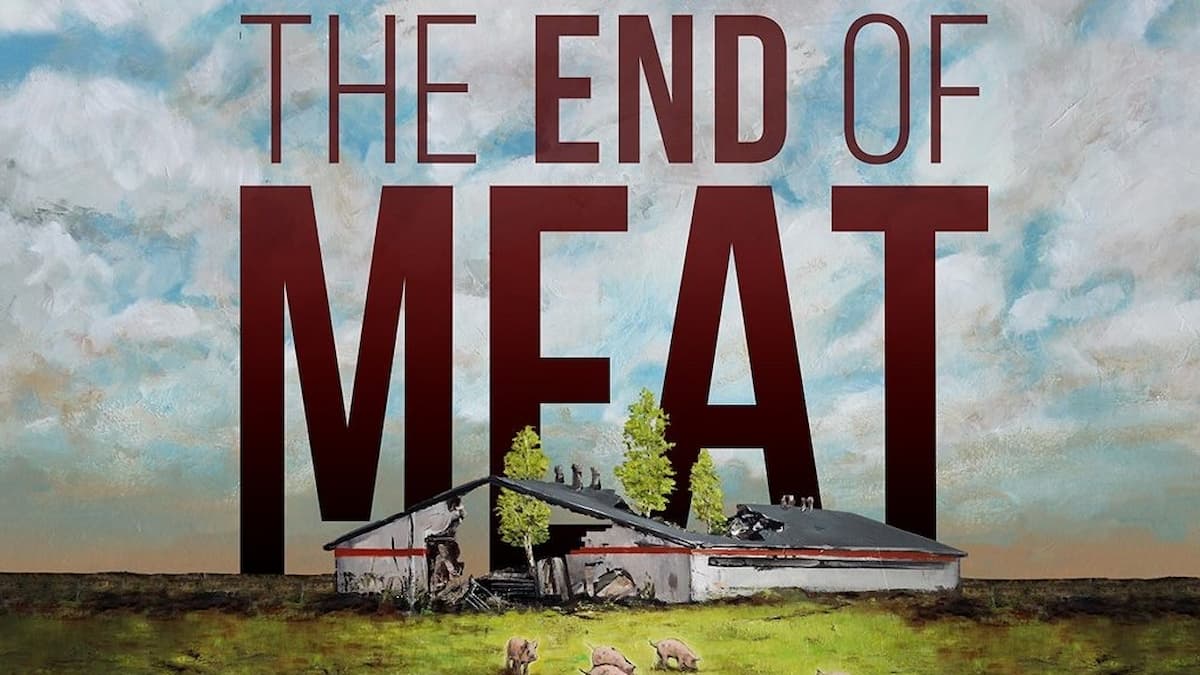 Movie poster for the documentary, The End of Meat, showing a crumbling down factory building on grass against a cloudy sky.