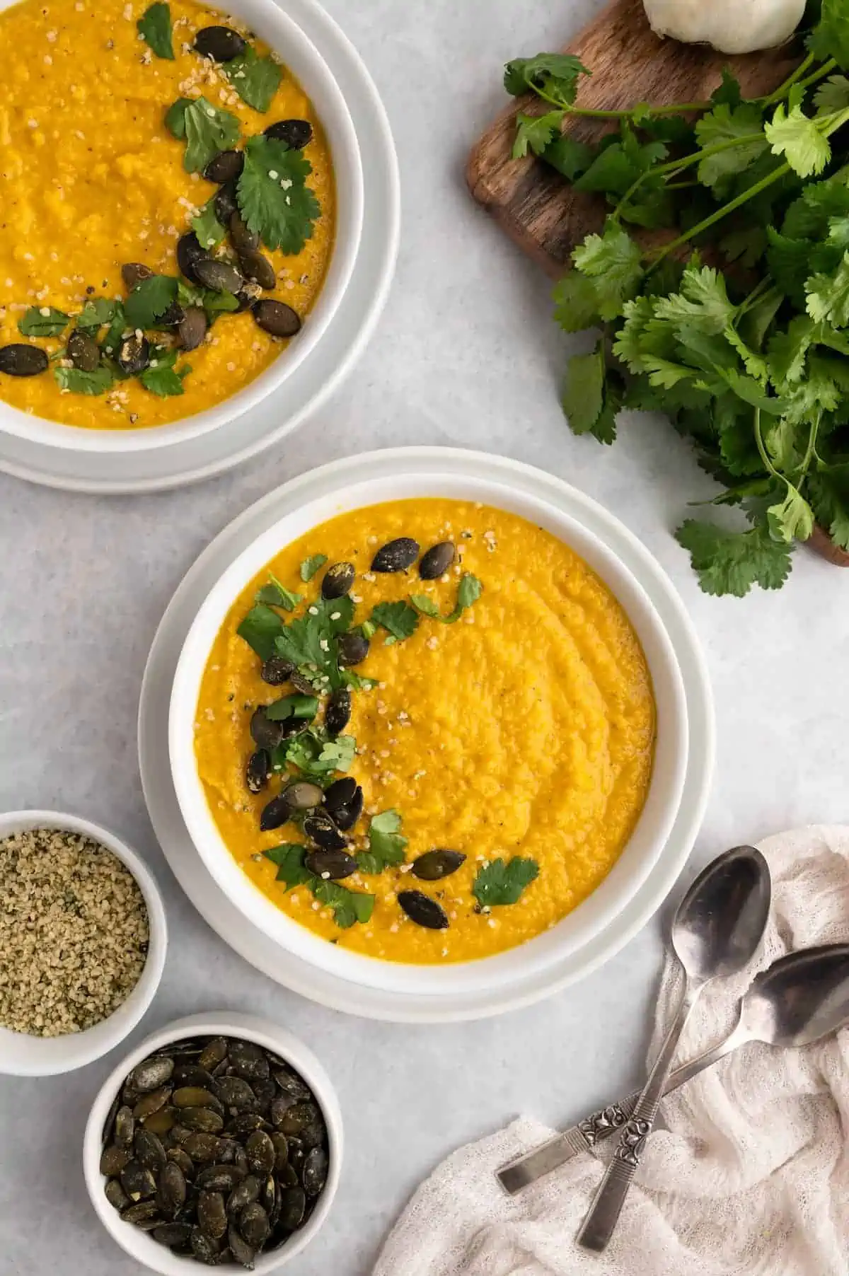 Two bowls of toor dal garnished with herbs, showing global vegan cuisines built on legumes.
