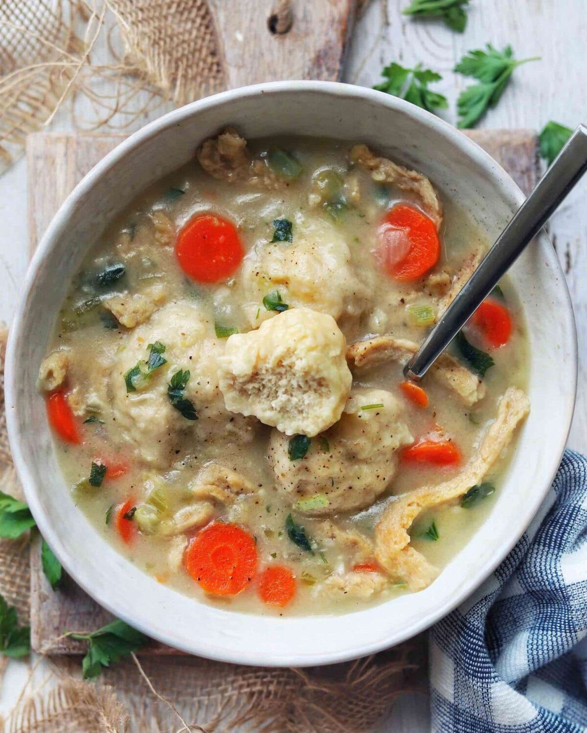 Vegan chicken and dumplings soup with soy curls and fluffy dumplings in broth.