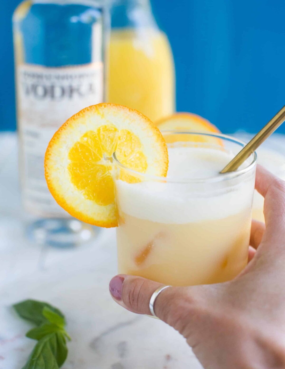 Creamsicle cocktails in glasses with orange slices and coconut milk—dairy-free summer drinks.