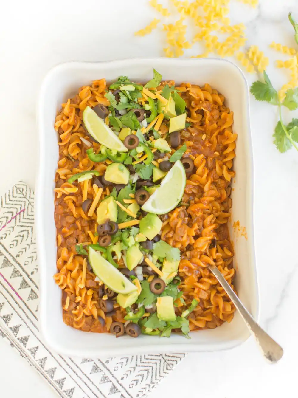 A casserole dish with vegan enchilada pasta.