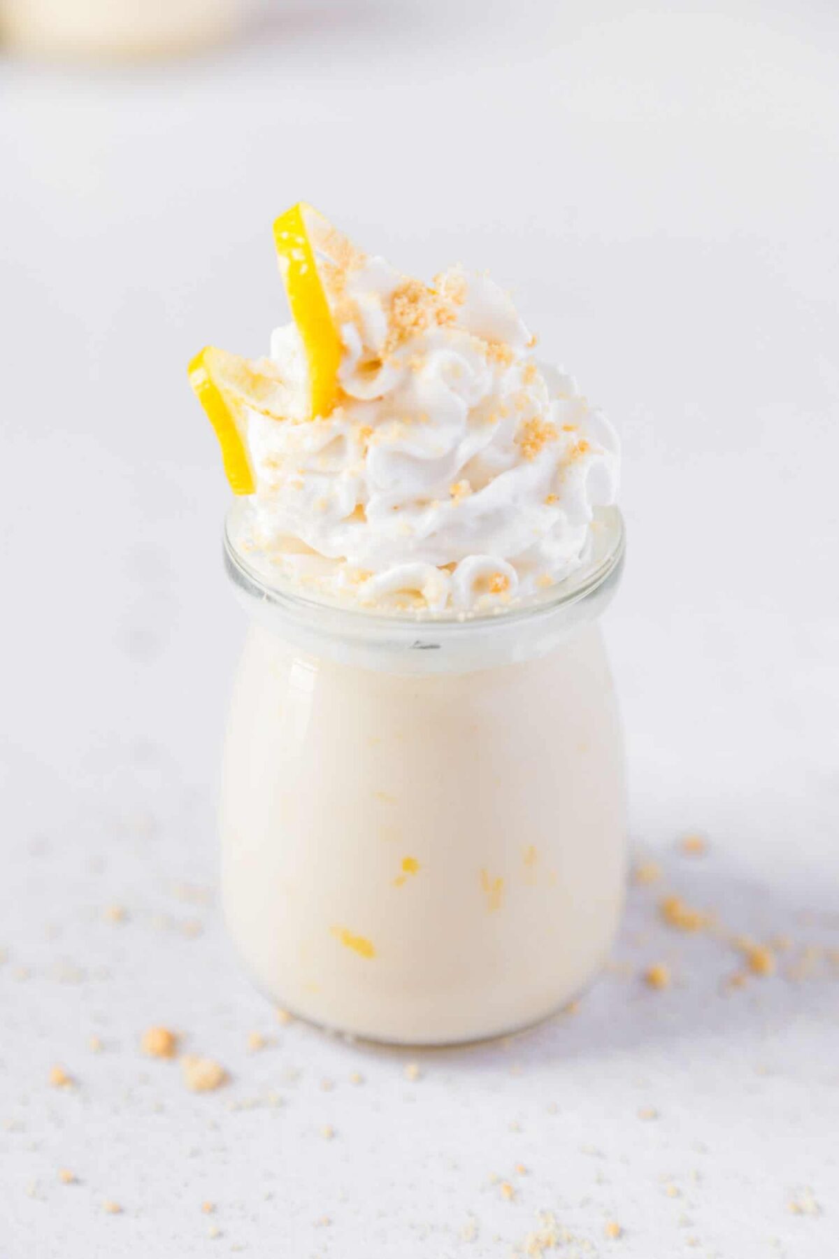 No-bake vegan lemon custard in jars topped with whipped coconut cream and lemon zest—light and tangy.