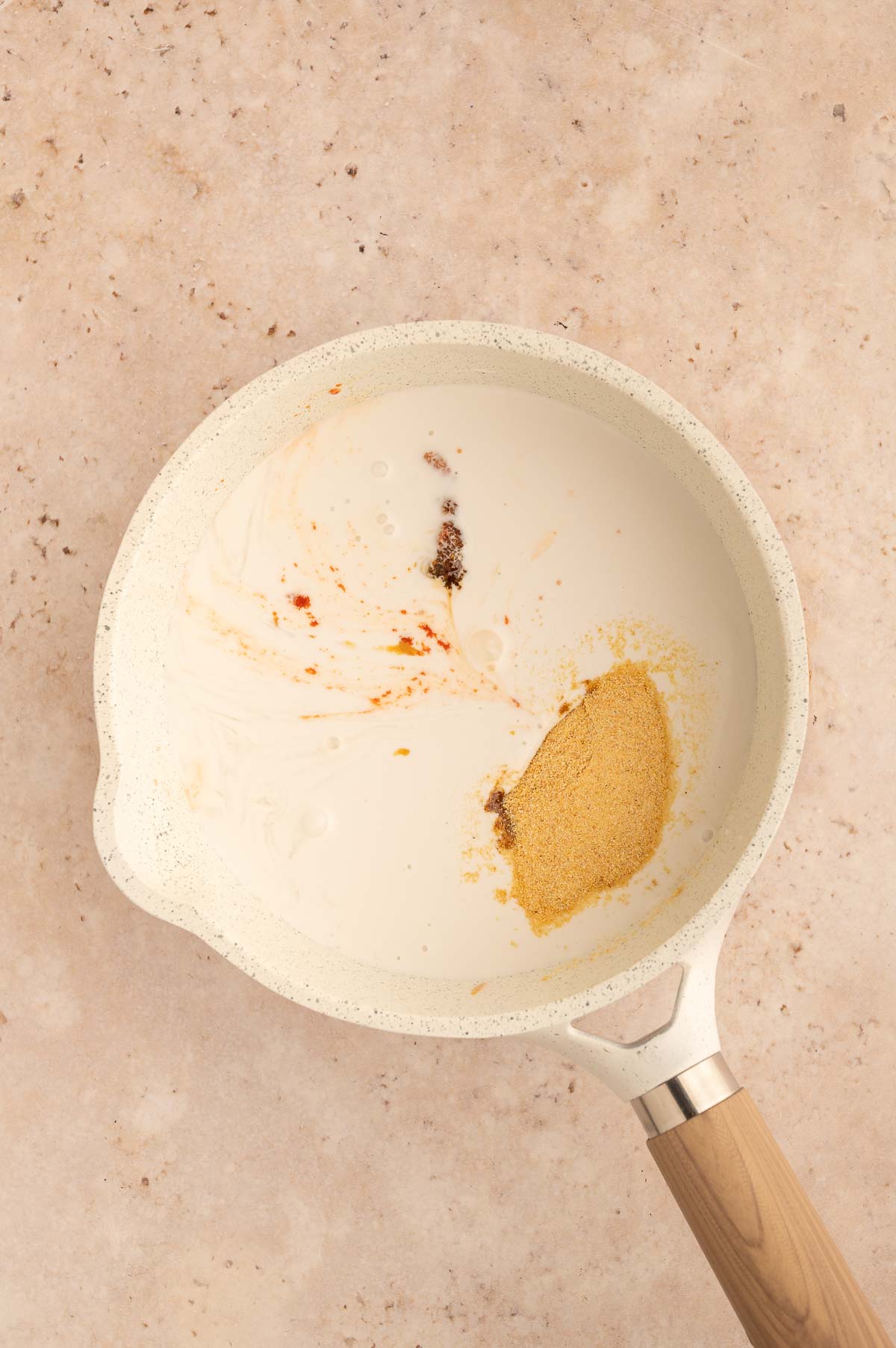 Coconut milk and spices ready to be mixed for a vegetarian panang curry dish.