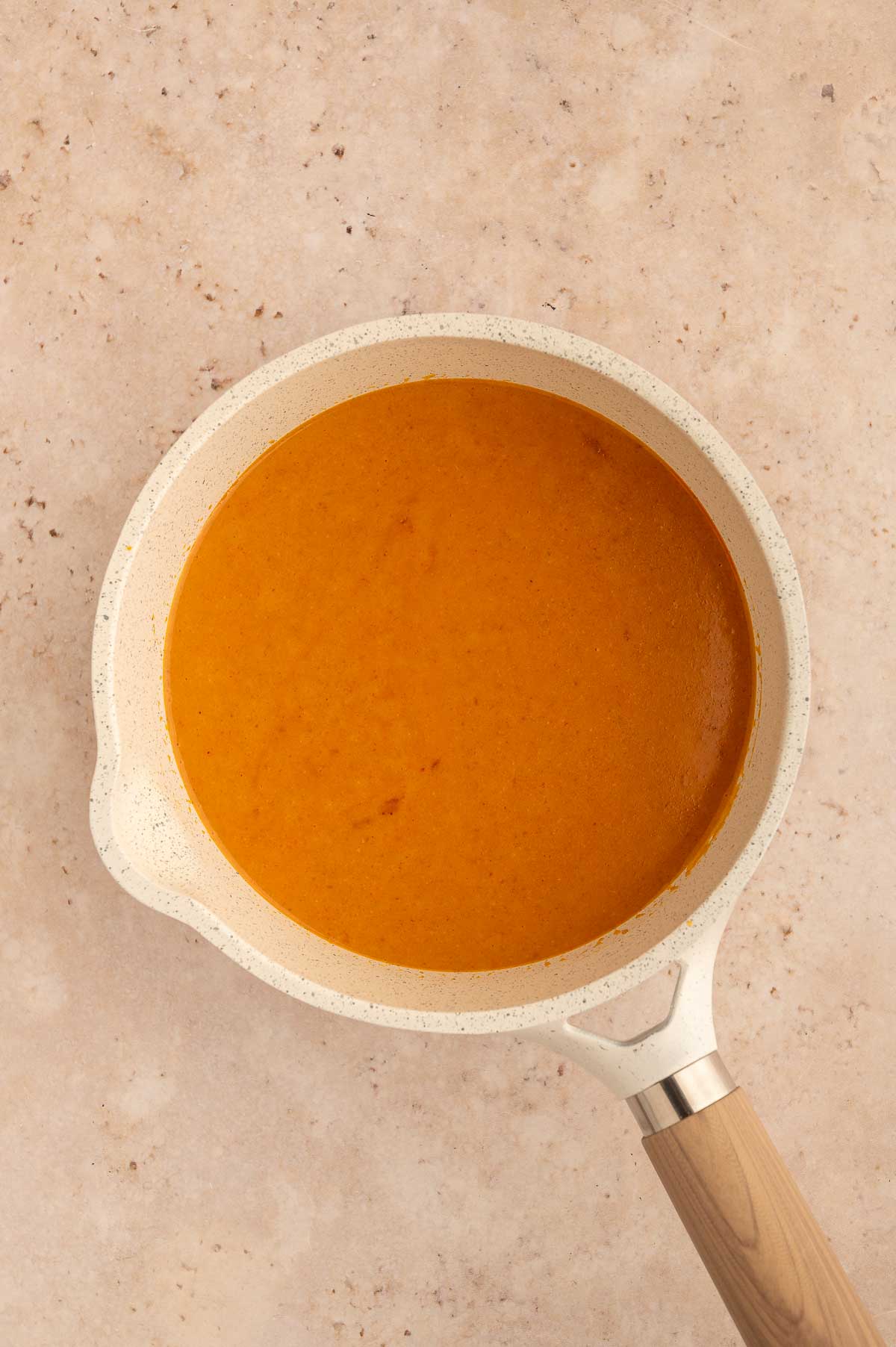 Ingredients for veggie panang curry sauce mixed and simmering.