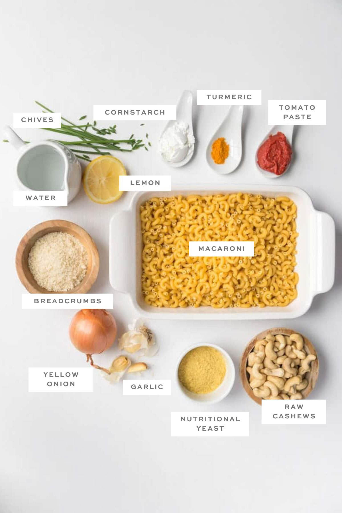 Ingredients for a vegan baked mac and cheese casserole with labels.