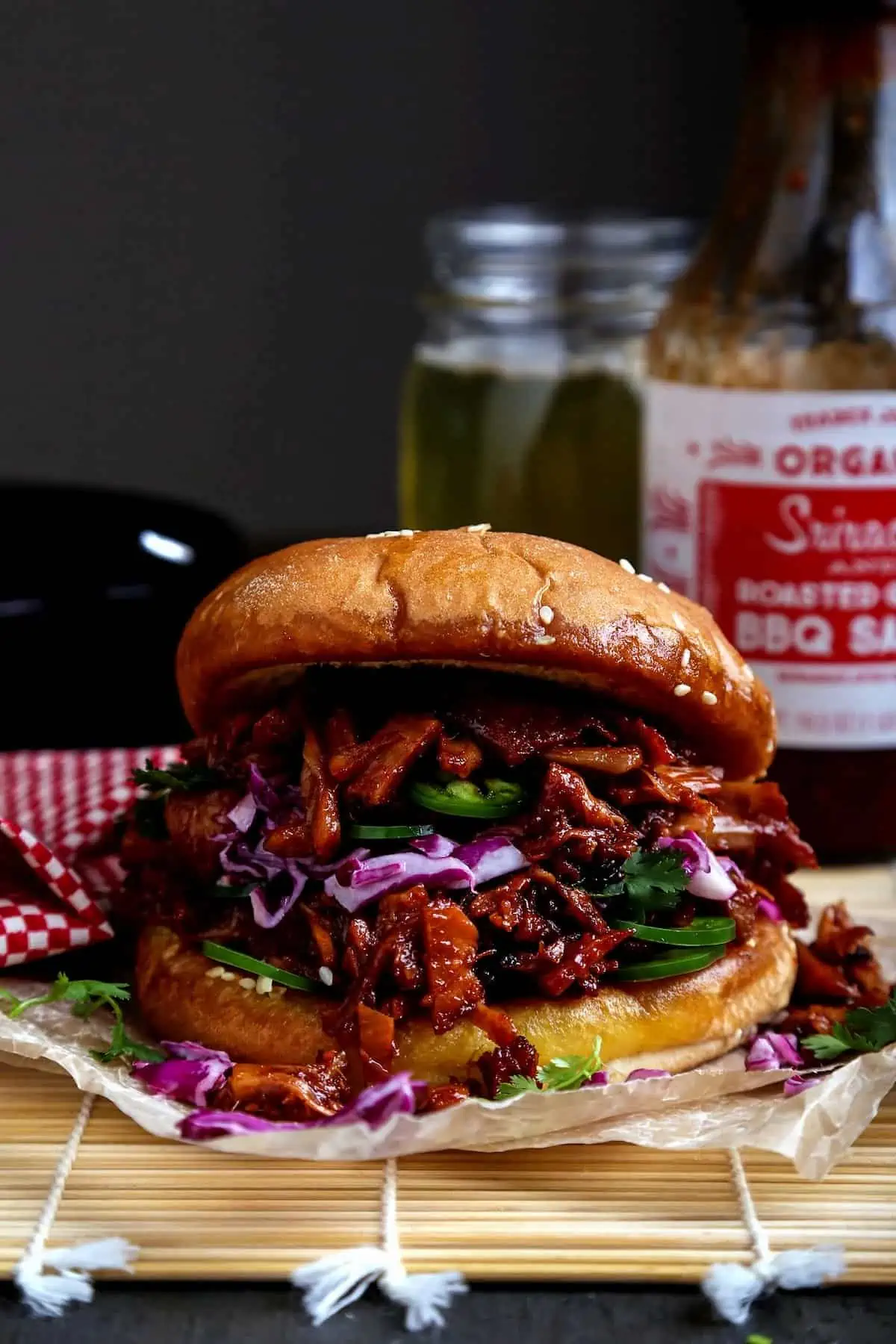 Vegan pulled jackfruit sandwich on a bun with red cabbage and jalapeños—BBQ classic made plant-based.