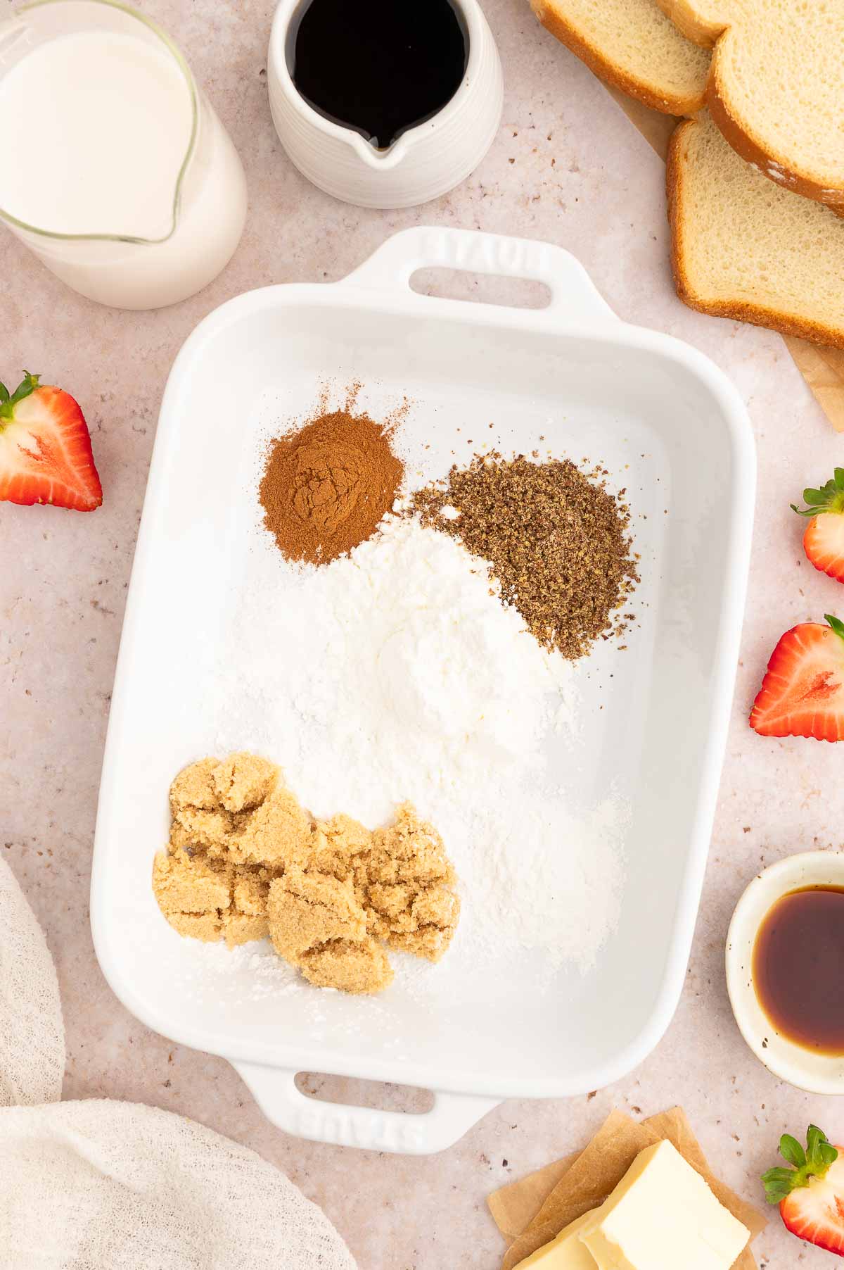 Dry ingredients used to make vegan French toast in a casserole dish.