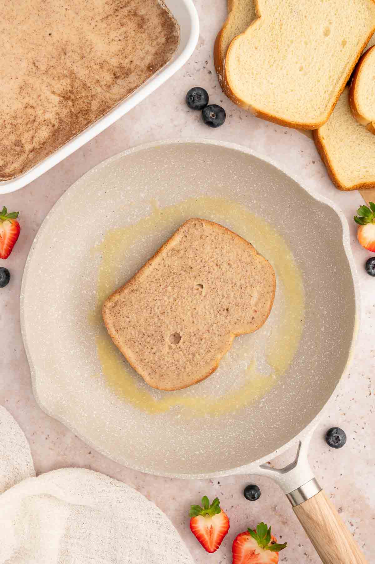 Vegan French toast being browned in a skillet.