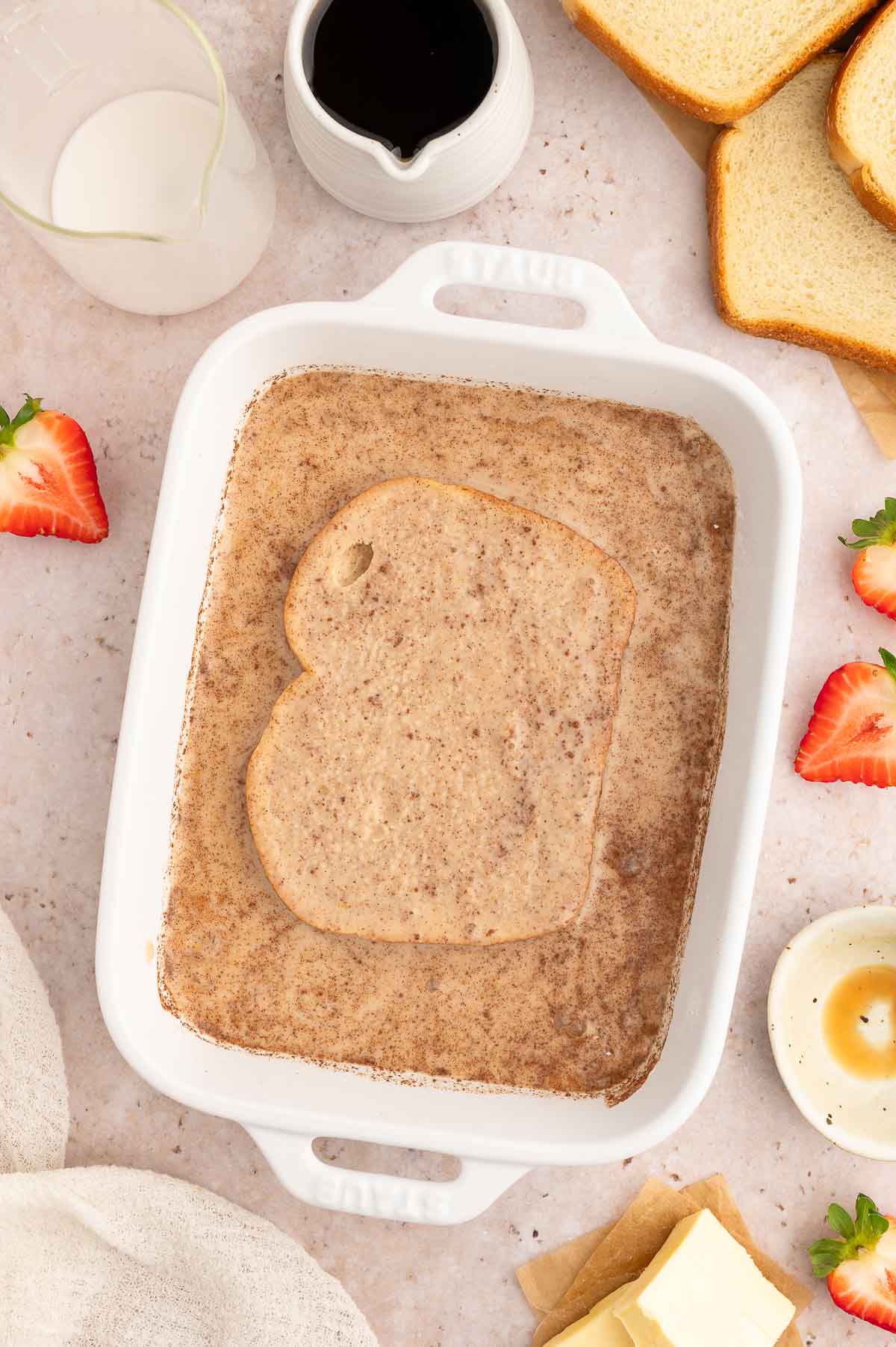 A piece of bread completely coated to make vegan French toast.