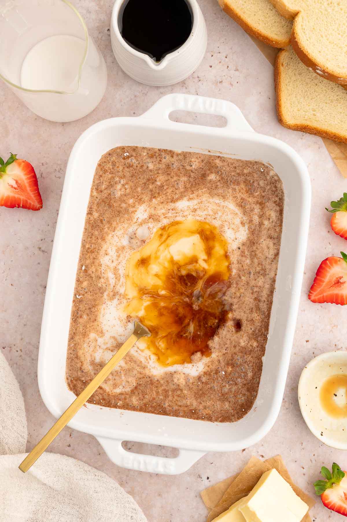 Wet and dry ingredients for vegan French toast in a casserole dish.