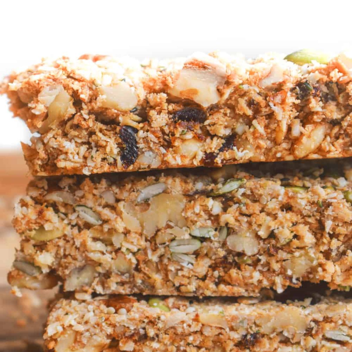 A close-up shot of stacked granola bars, a healthy vegan snack.