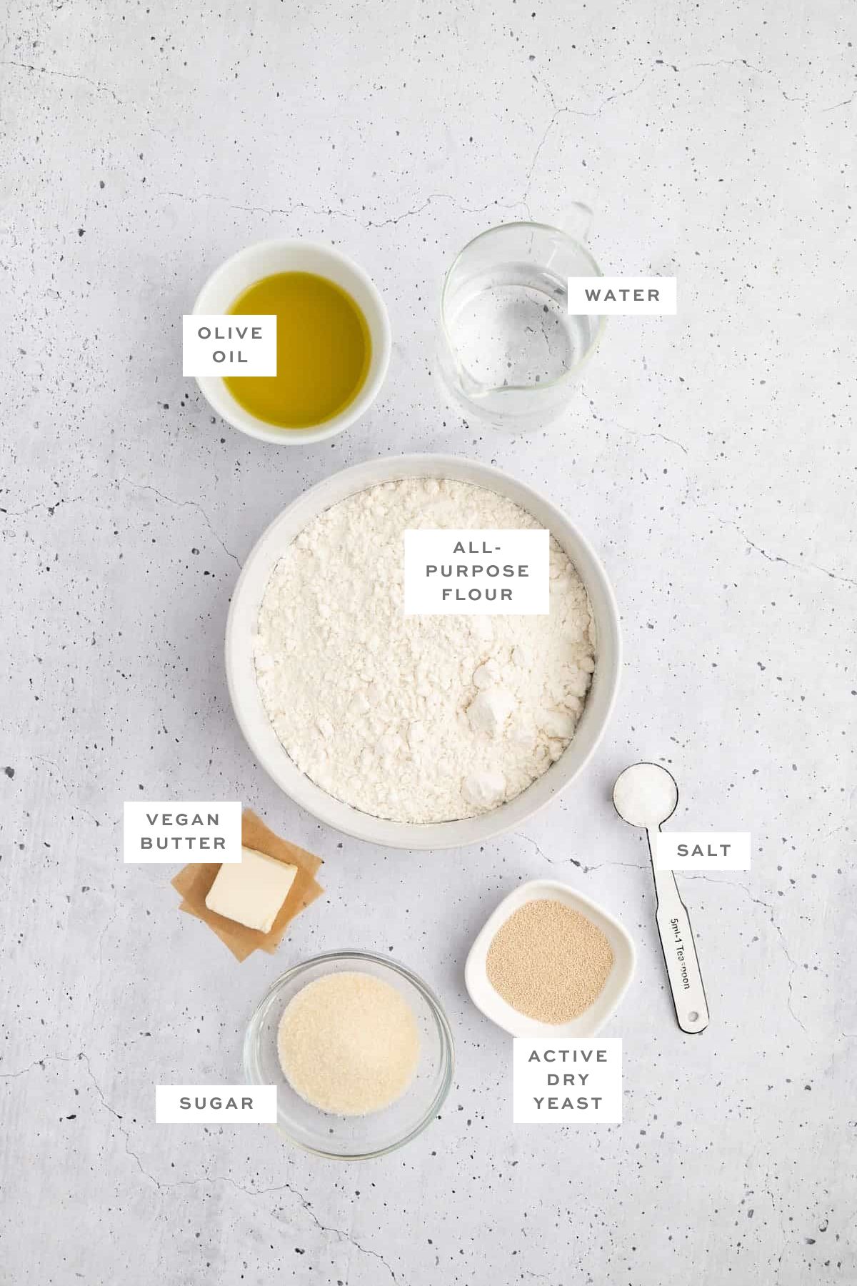 Ingredients for vegan pesto bread with labels.