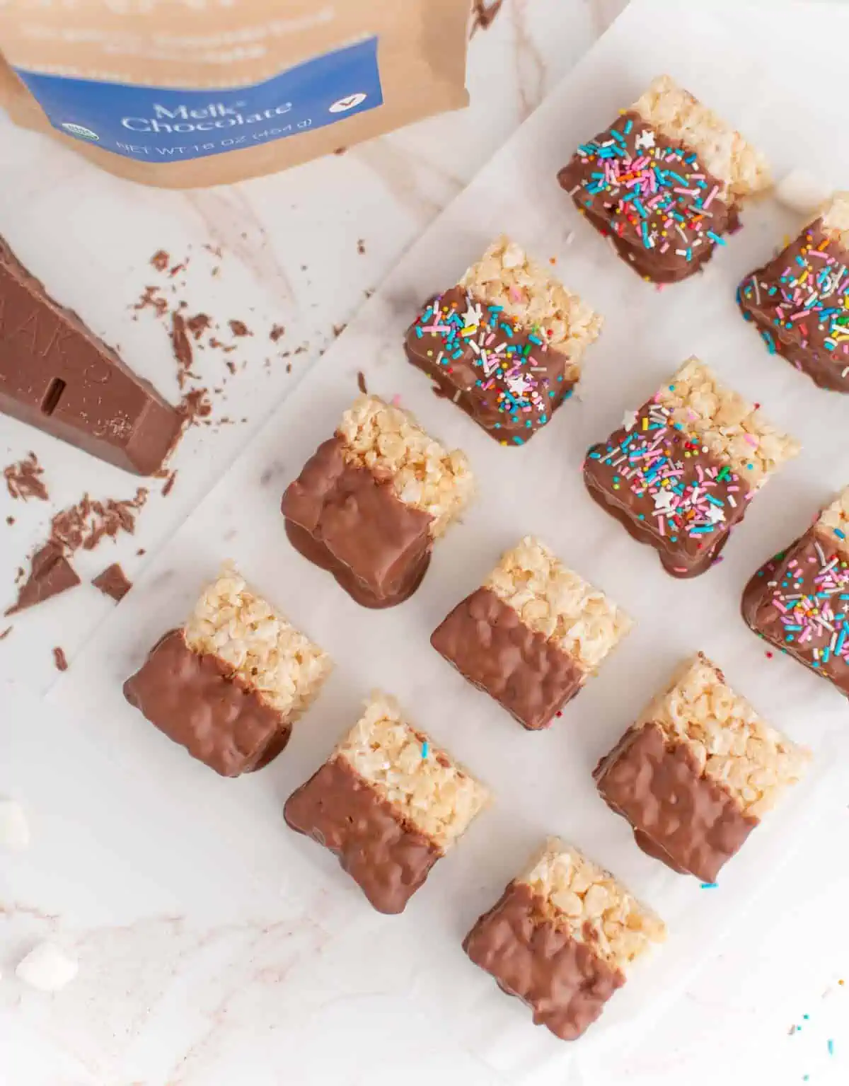 Vegan chocolate rice crispy treats dipped in dairy-free chocolate and vegan sprinkles.