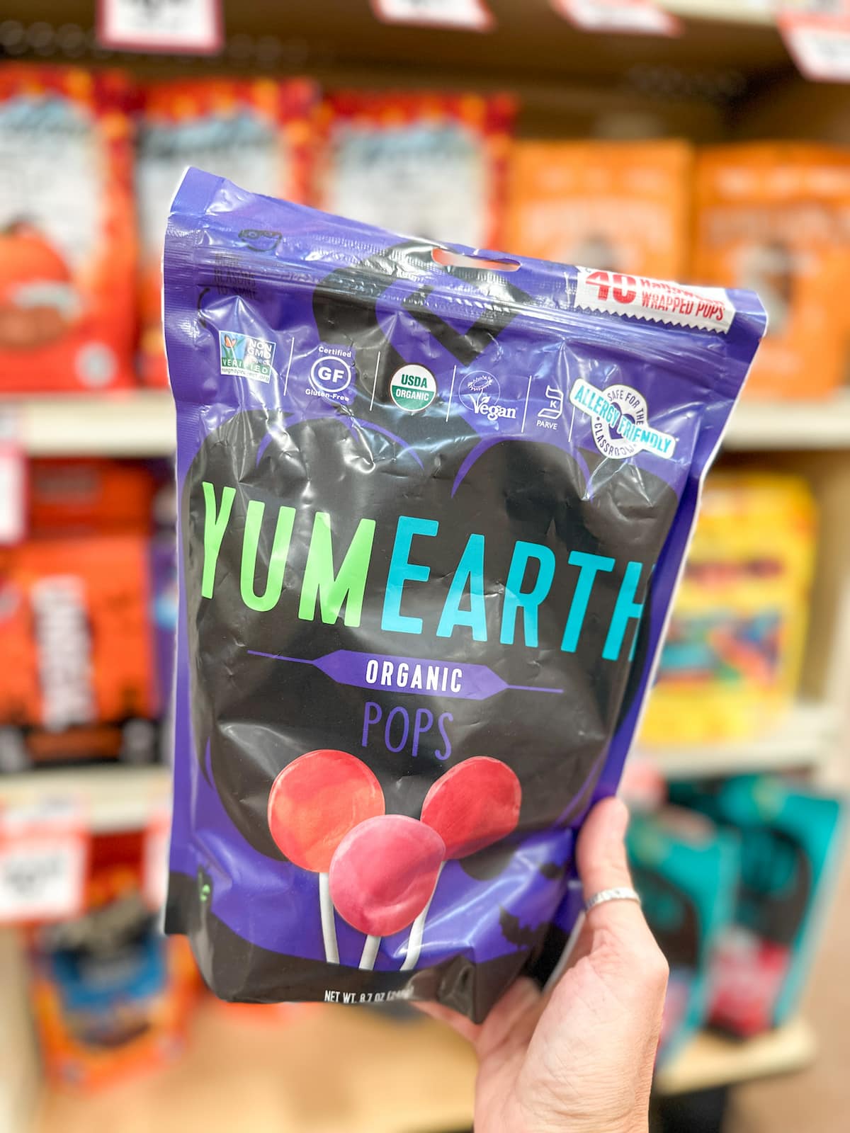 Package of YumEarth organic fruit pops in festive Halloween bag.
