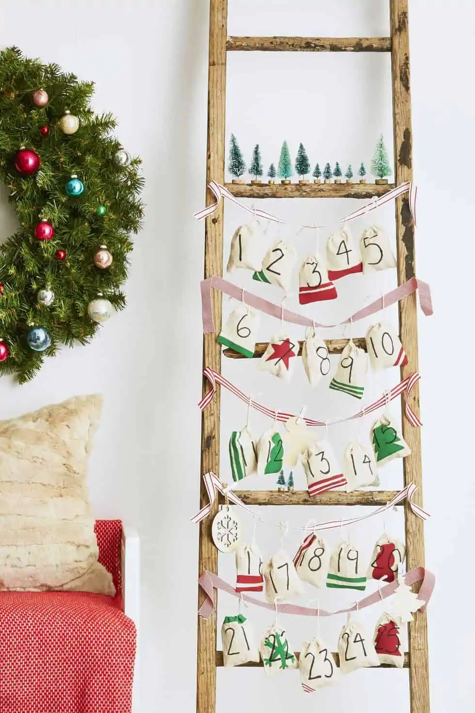 Rustic ladder with hanging bags you can fill with Christmas treats as a homemade advent calendar.