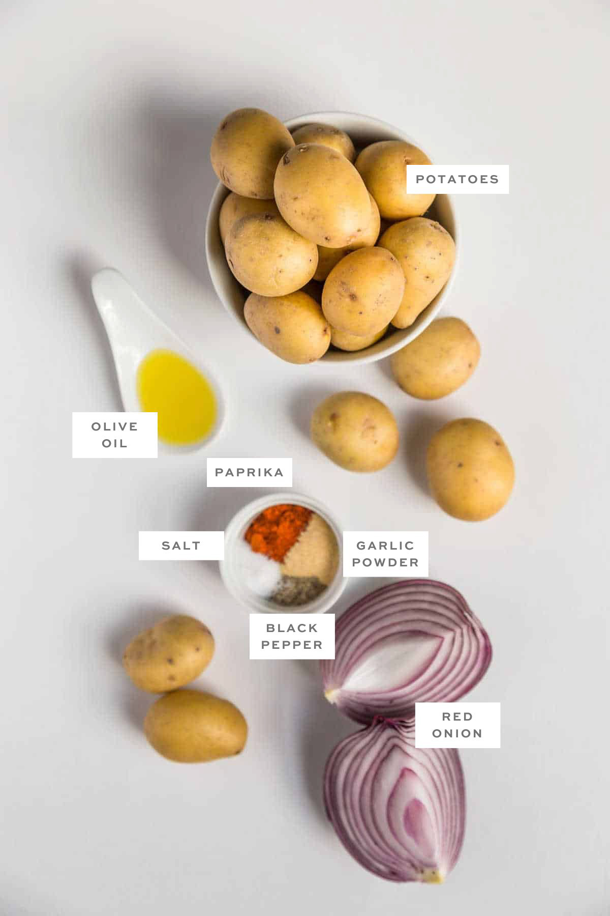 Labeled ingredients for air-fried home fries, including baby potatoes, red onion, and seasonings.
