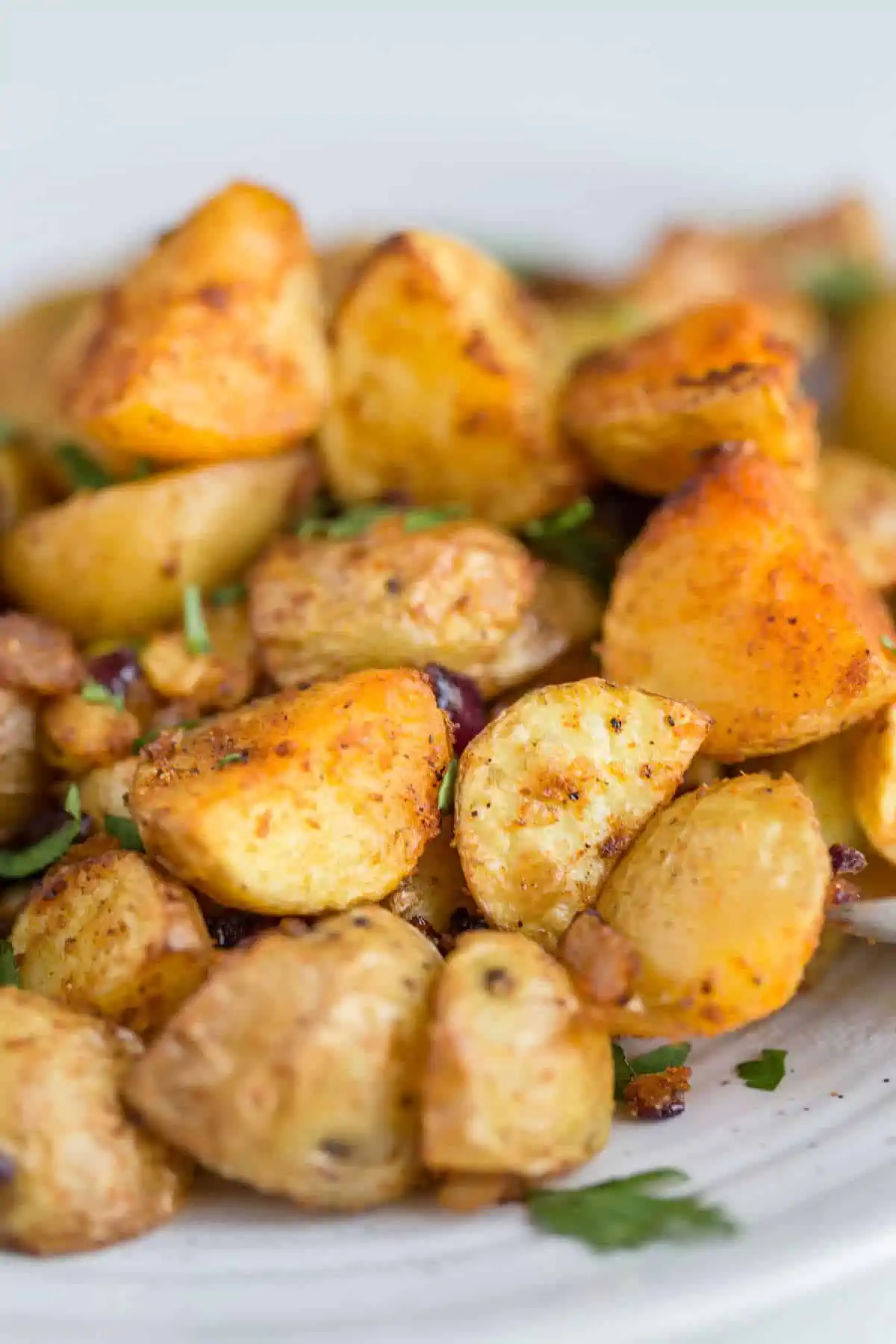 Ultra crispy home fries served on a white plate, golden and seasoned with paprika.