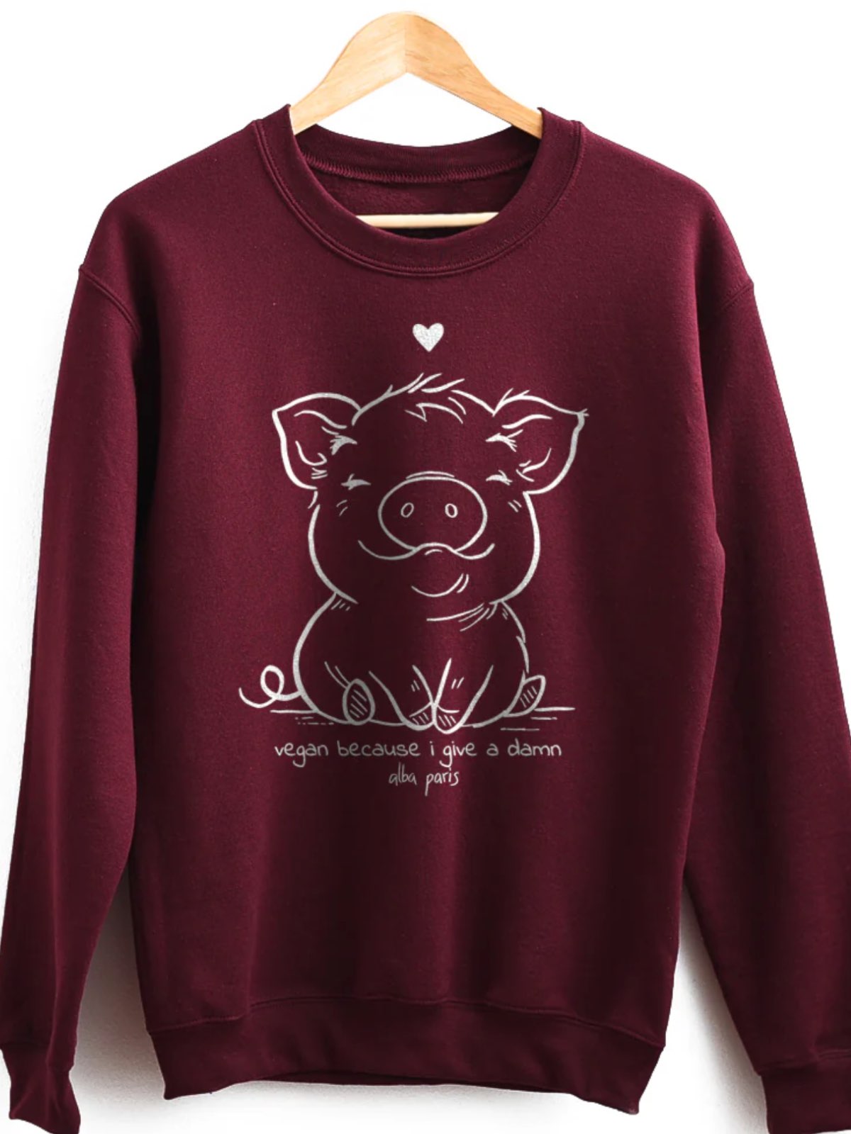 Cute maroon colored vegan pig sweatshirt from Alba Paris with an illustrated pig and the text "vegan because I give a damn."