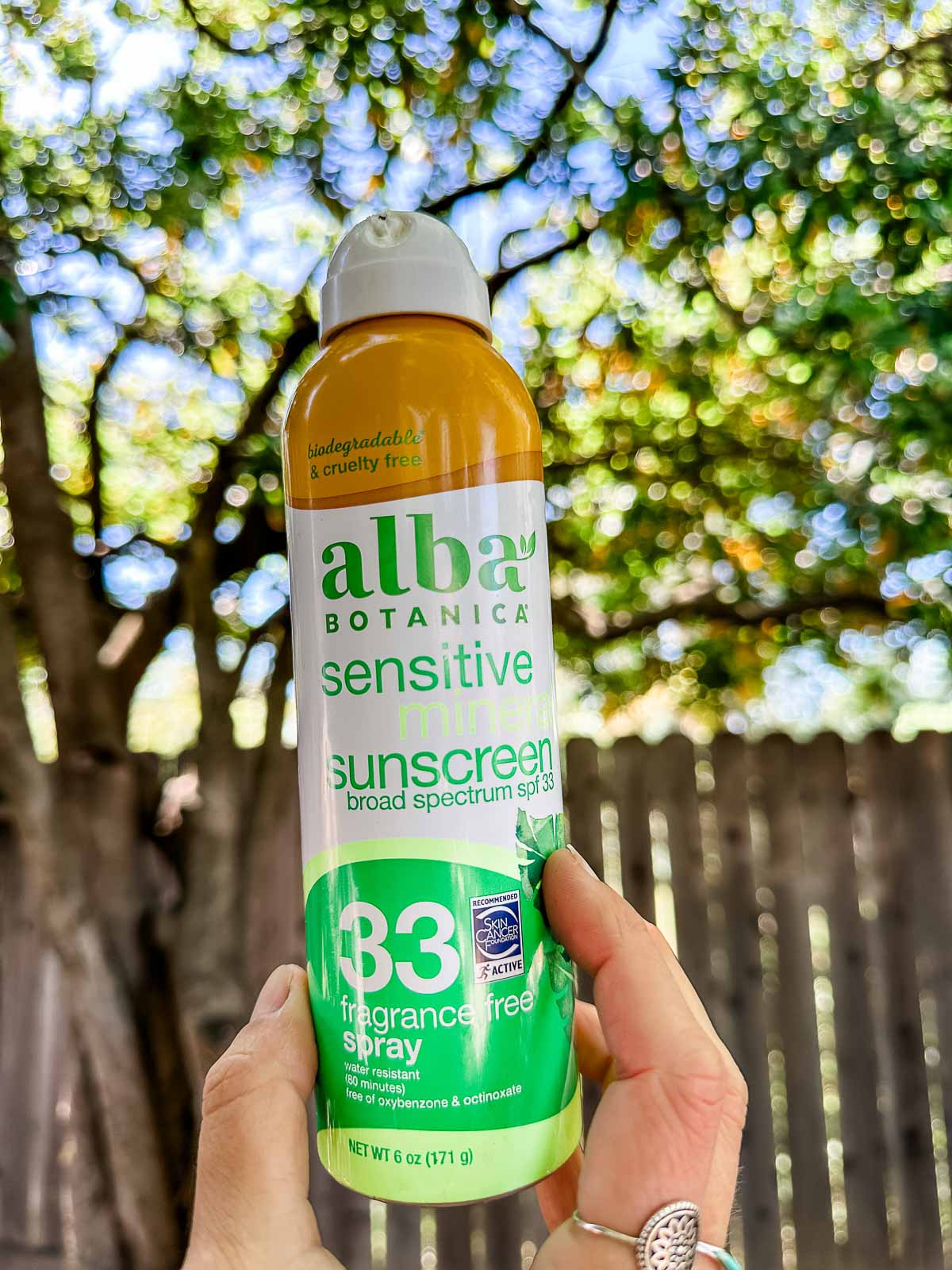 A container of Alba brand vegan sunscreen spray.