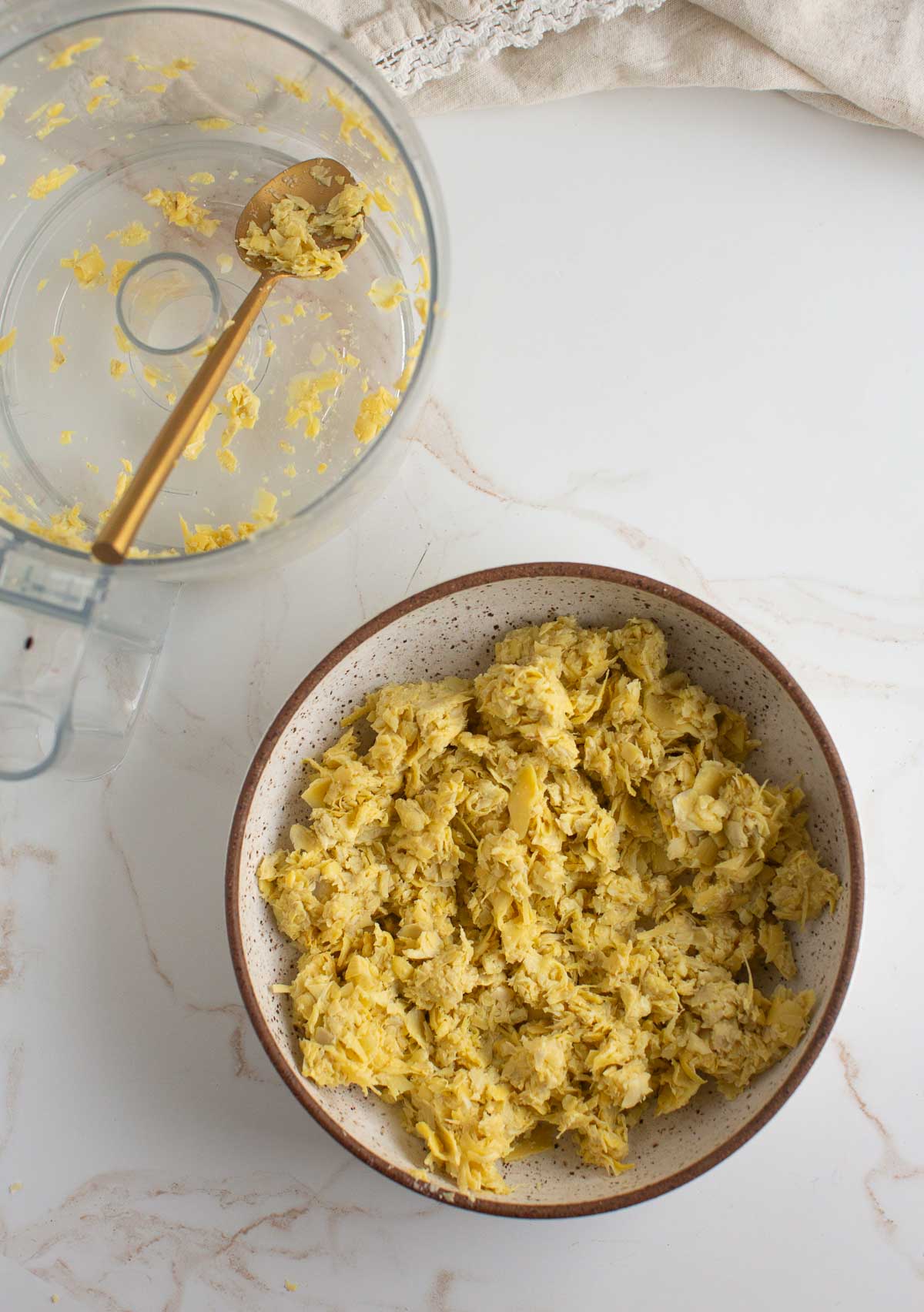 Chopped artichokes processed in a food processor.