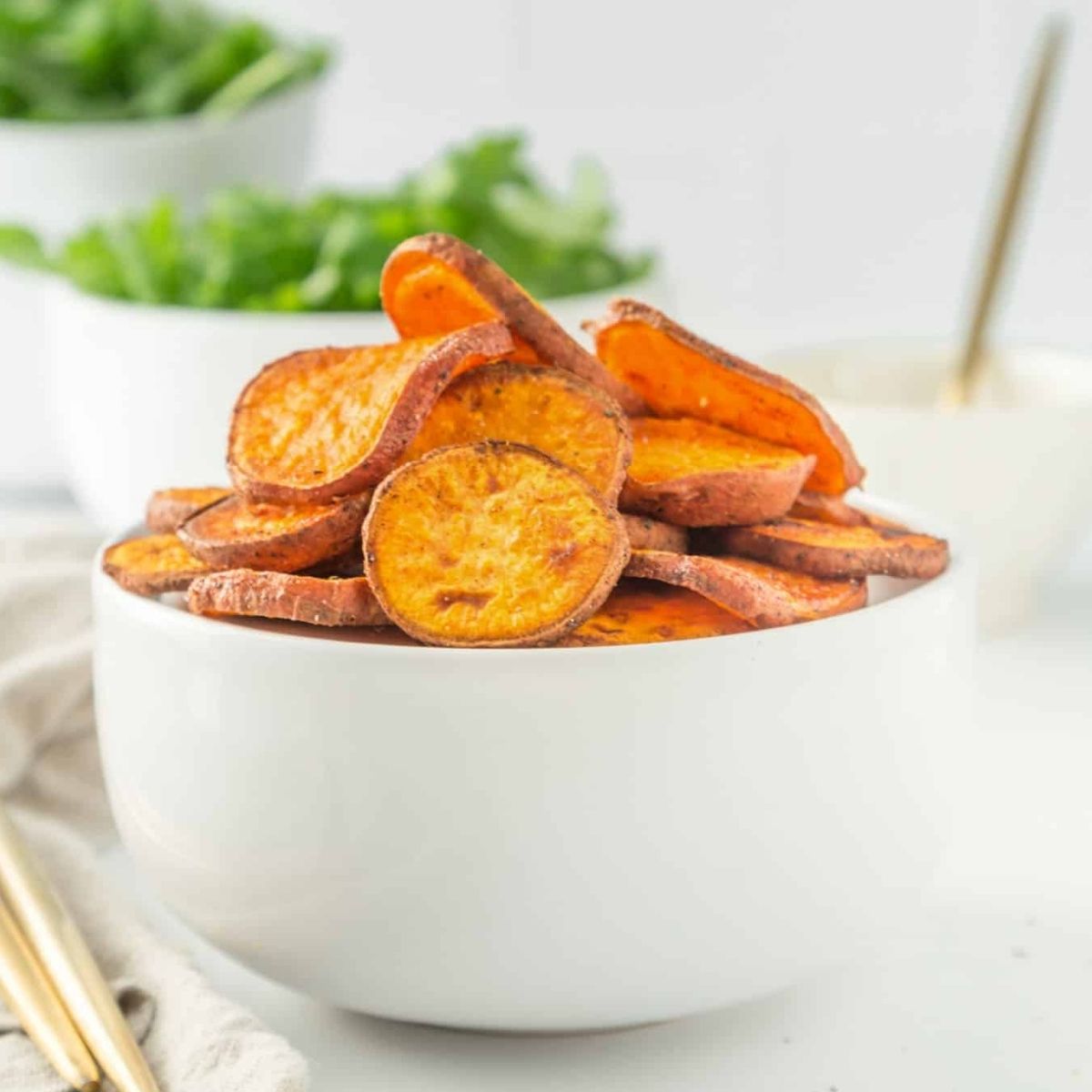 A bowl of baked sliced sweet potatoes.