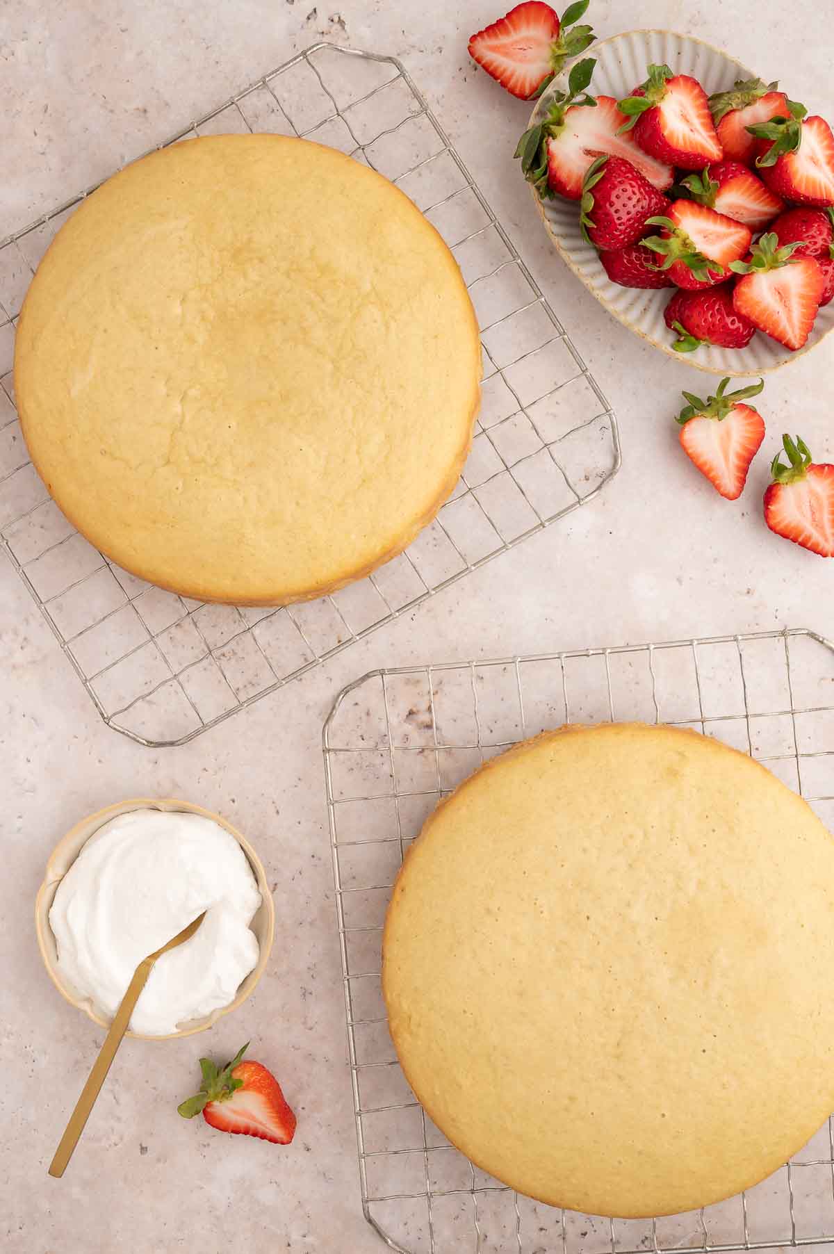 Golden round strawberry shortcakes cooling on wire racks.