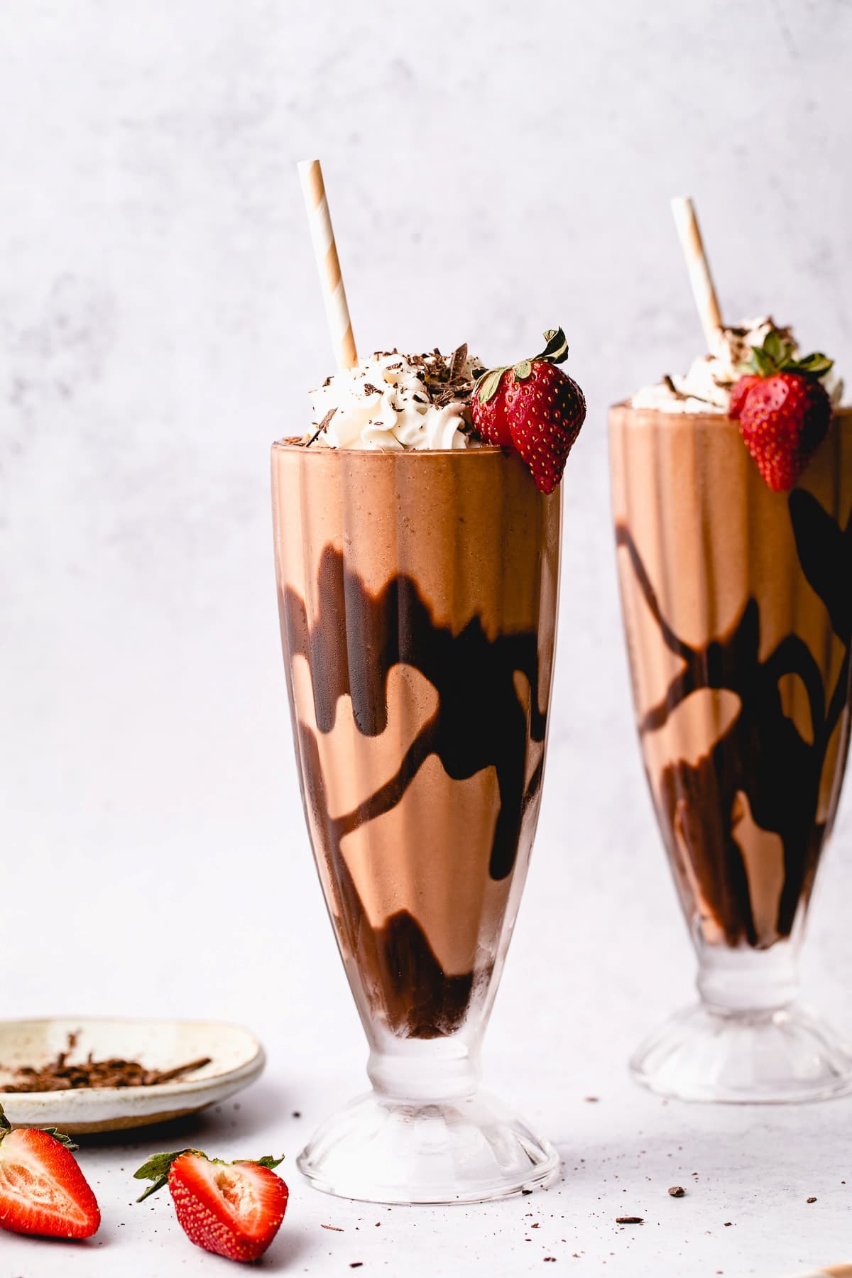 Two glasses of vegan chocolate milkshakes.