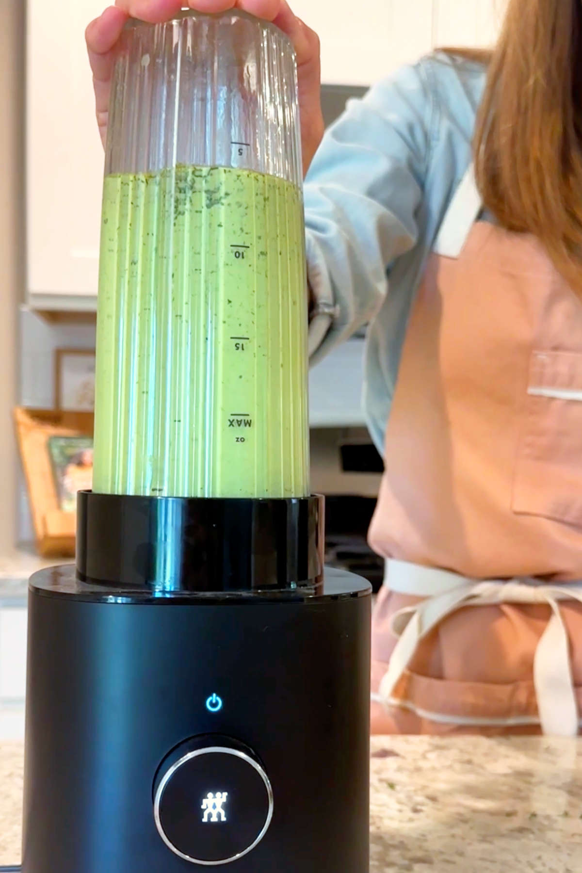 Vegan green goddess dressing blending smooth in a high-powered blender.