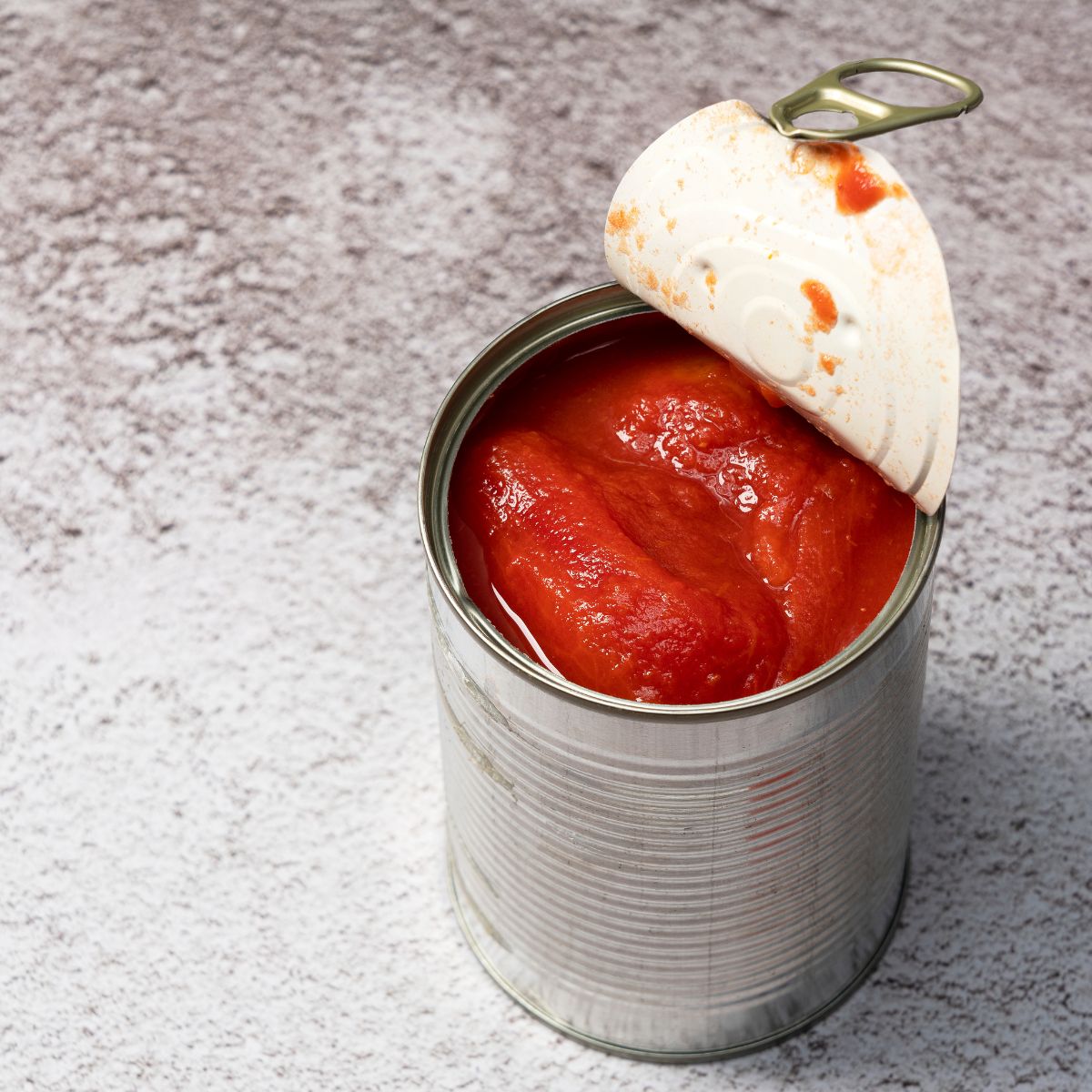 Canned tomatoes on a countertop.