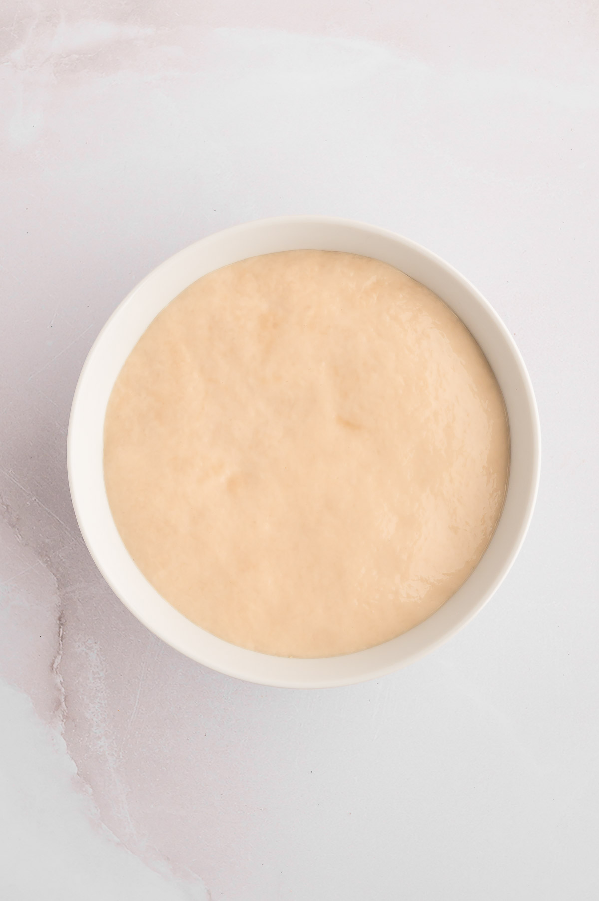 Yeast and water mixed together in a bowl.