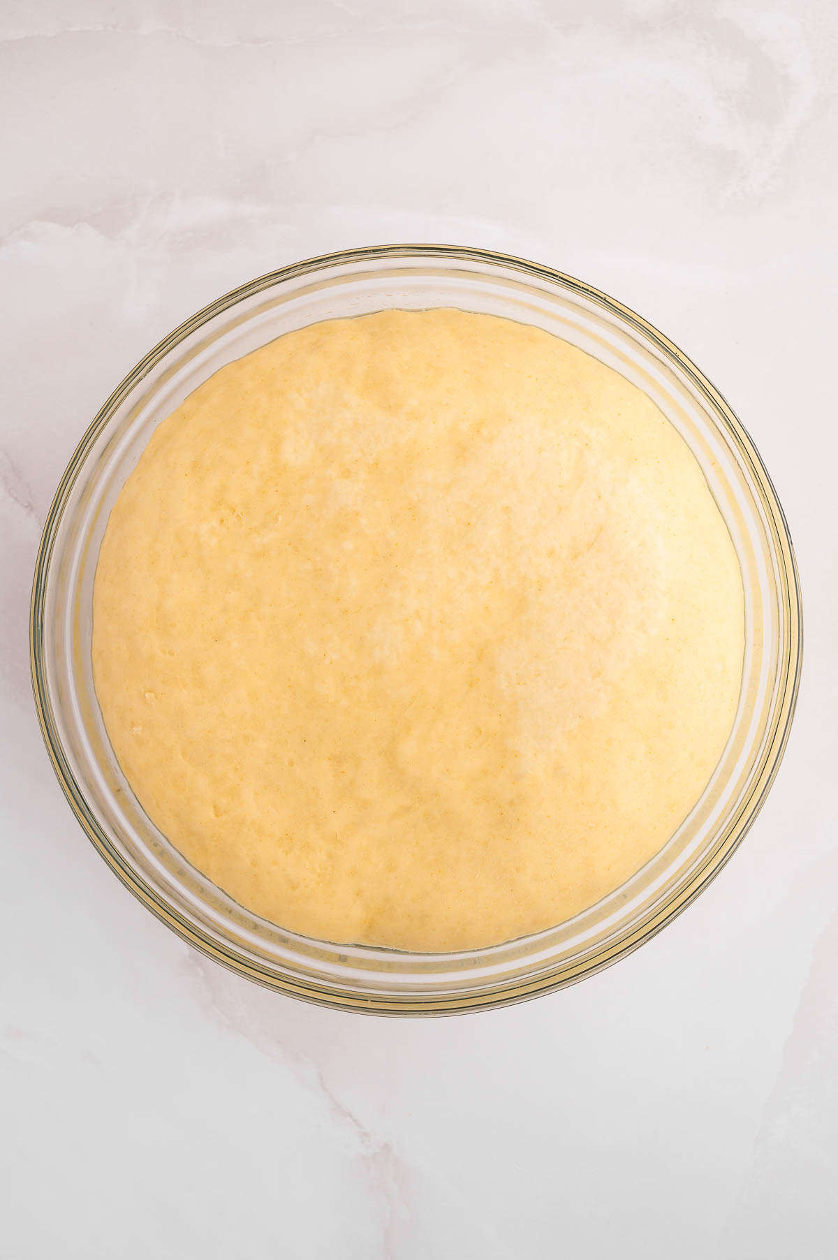 Proofed dough in a bowl.